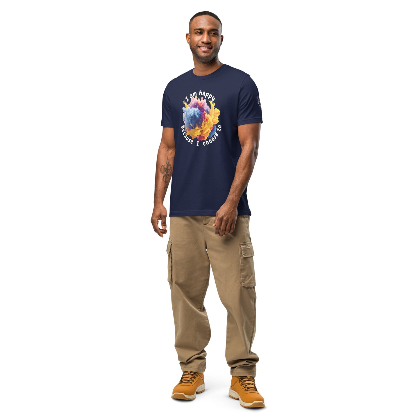 Product mockup. Smiling man in beige cargo pants, navy t-shirt with colorful powder burst in the center, text reads “I am happy because I choose to.”