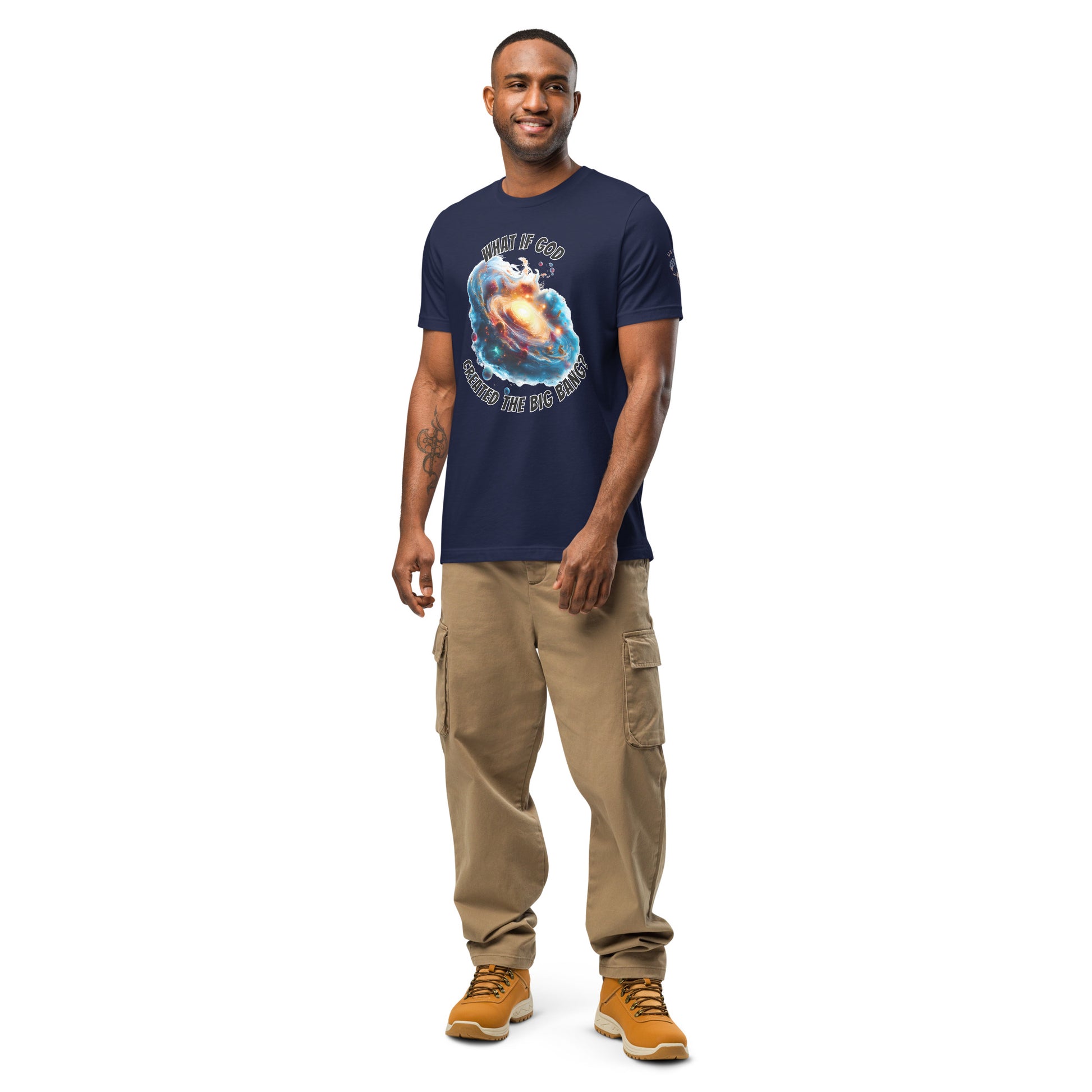 Product mockup. A man stands wearing a navy blue t-shirt with a colorful galaxy swirl and the phrase "WHAT IF GOD CREATED THE BIG BANG?" above and below the design.