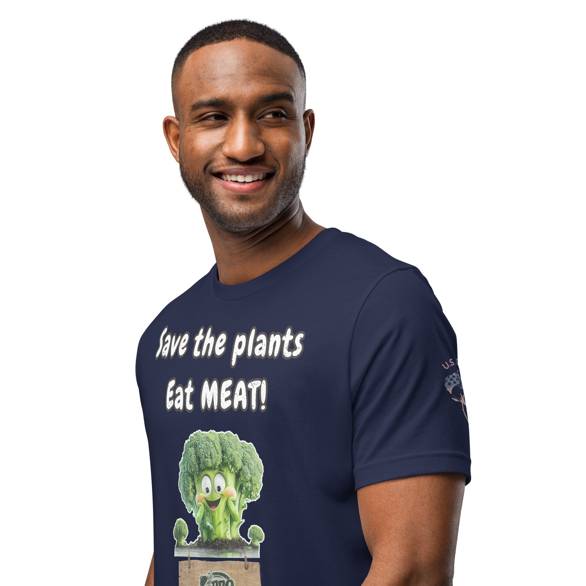 Product mockup. Smiling man wearing a navy blue T-shirt with the text "Save the plants Eat MEAT!" and a cartoon broccoli graphic.