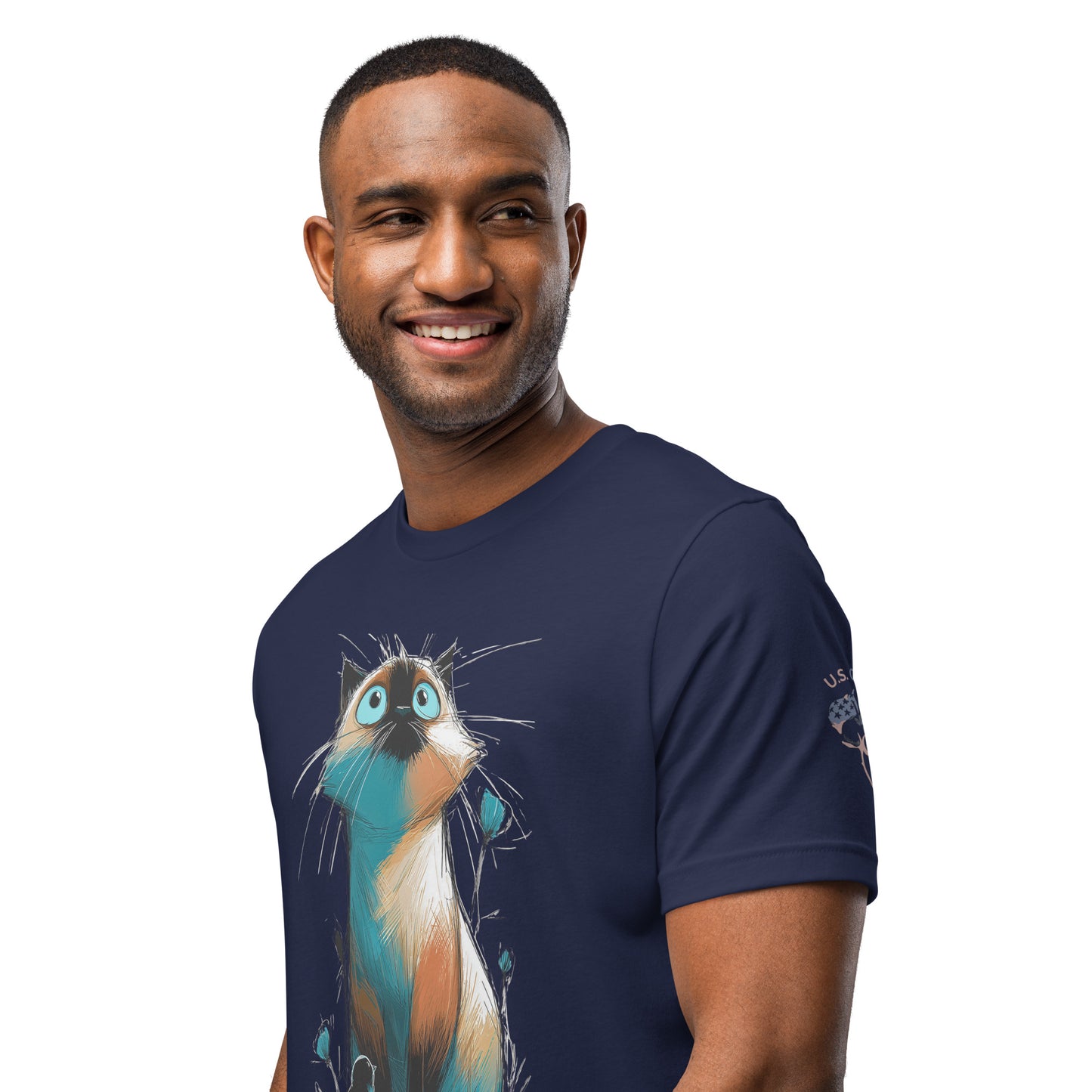Product mockup. Smiling man wearing a navy blue T-shirt featuring an illustrated cat with large blue eyes and colorful sketchy details.