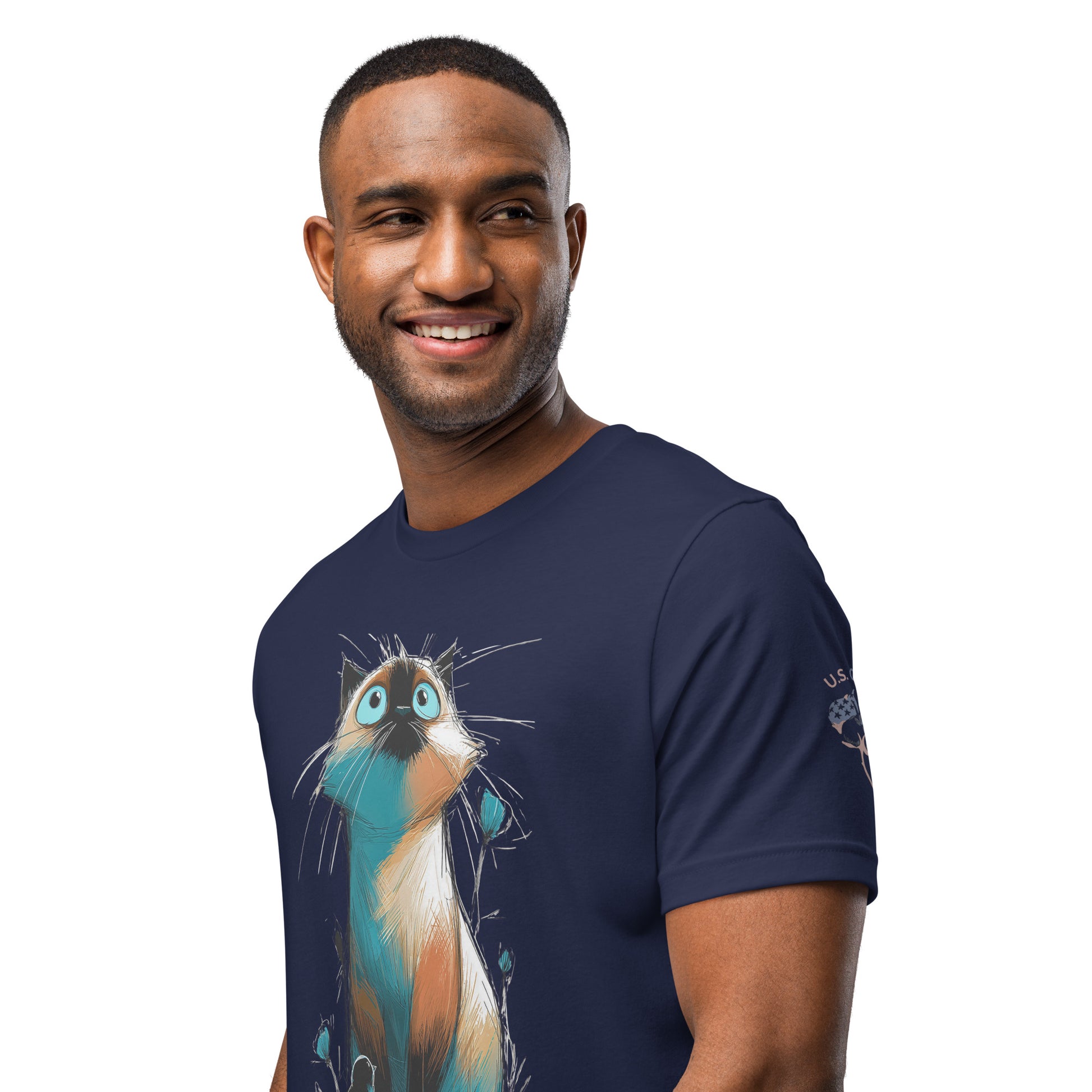 Product mockup. Smiling man wearing a navy blue T-shirt featuring an illustrated cat with large blue eyes and colorful sketchy details.