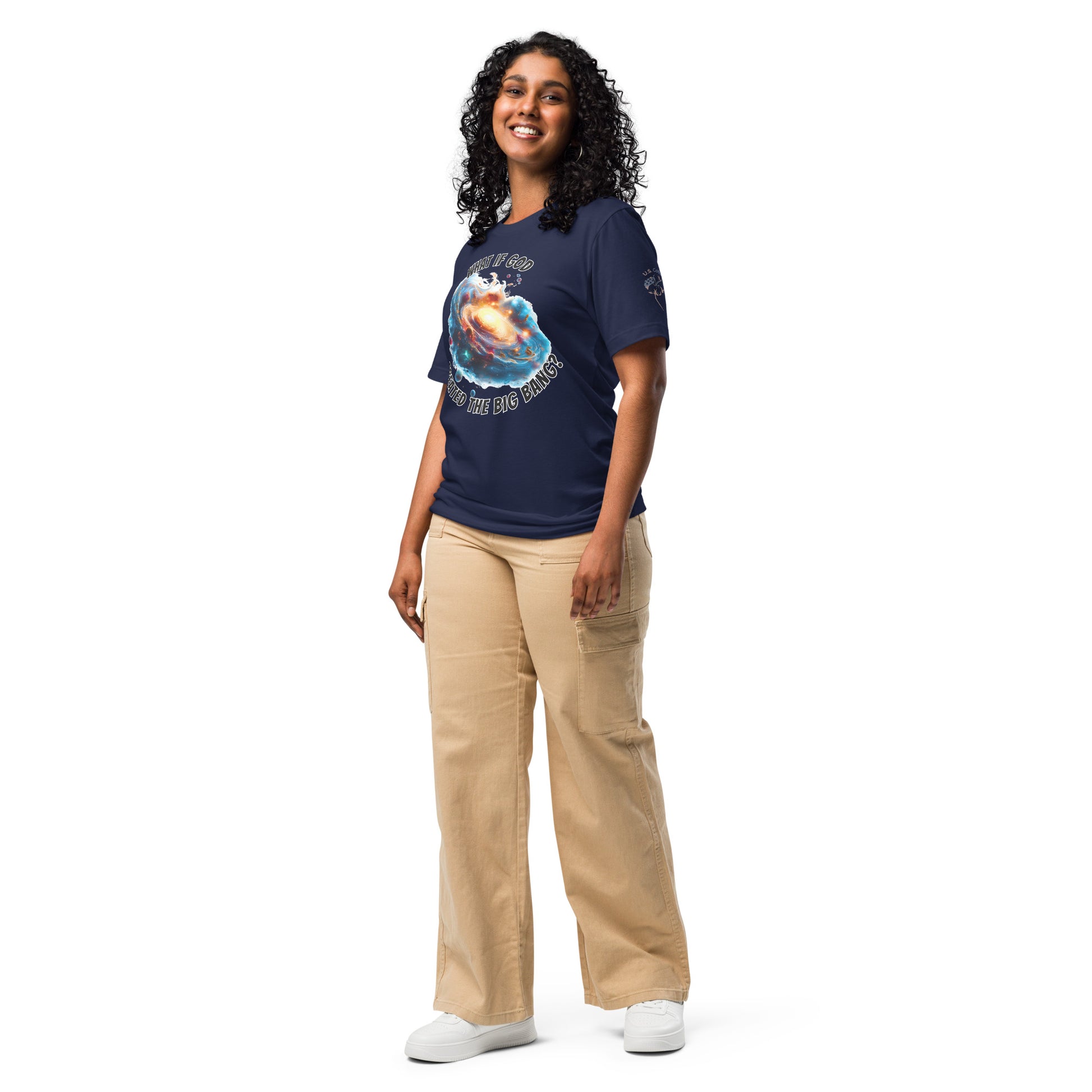 Product mockup. Smiling woman standing, wearing a navy blue T-shirt featuring a galactic explosion graphic with the words "WHAT IF GOD CAUSED THE BIG BANG?"