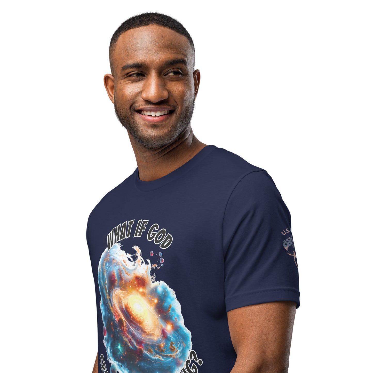 Product mockup. Smiling man standing, wearing a navy blue T-shirt featuring a galactic explosion graphic with the words "WHAT IF GOD CAUSED THE BIG BANG?"
