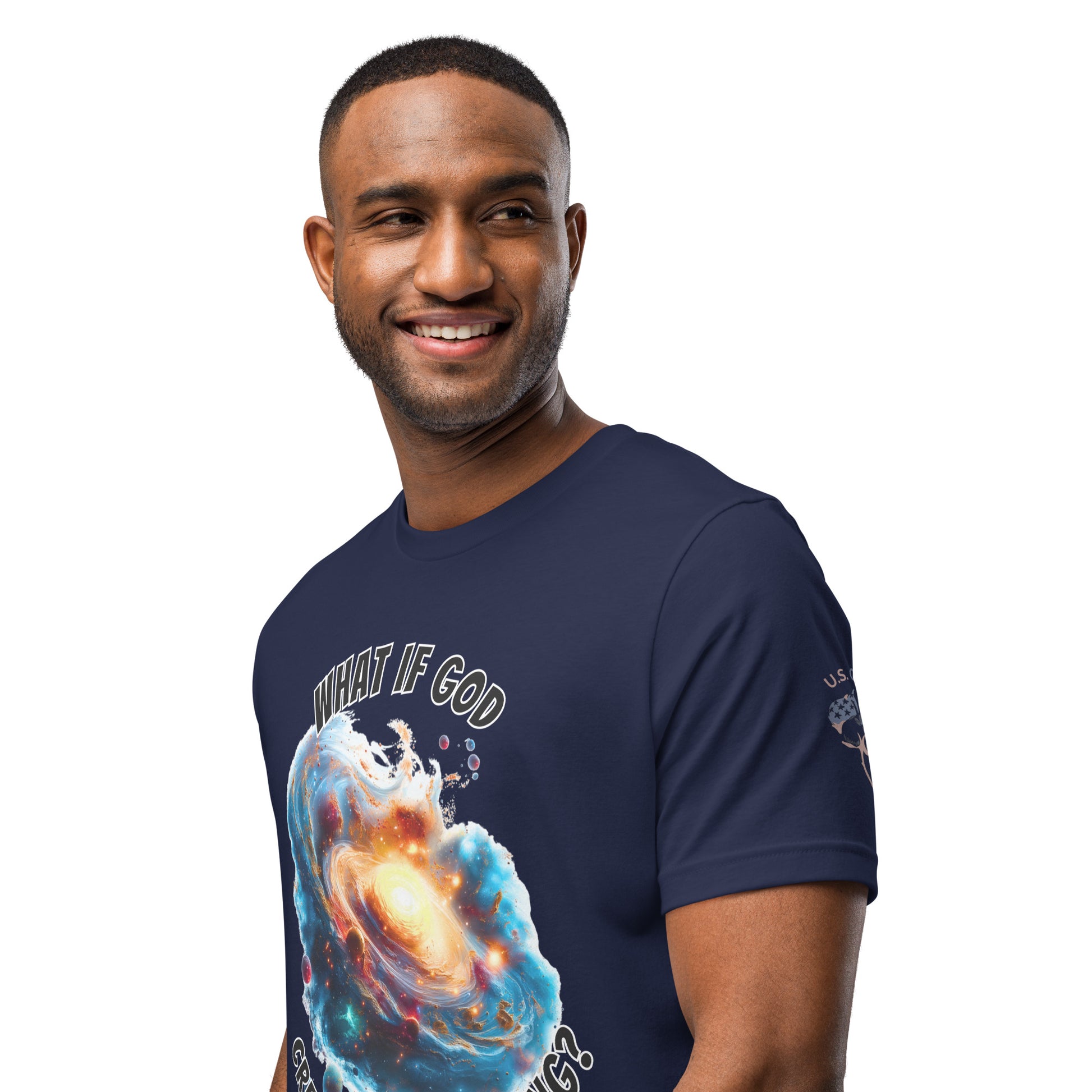 Product mockup. Smiling man standing, wearing a navy blue T-shirt featuring a galactic explosion graphic with the words "WHAT IF GOD CAUSED THE BIG BANG?"