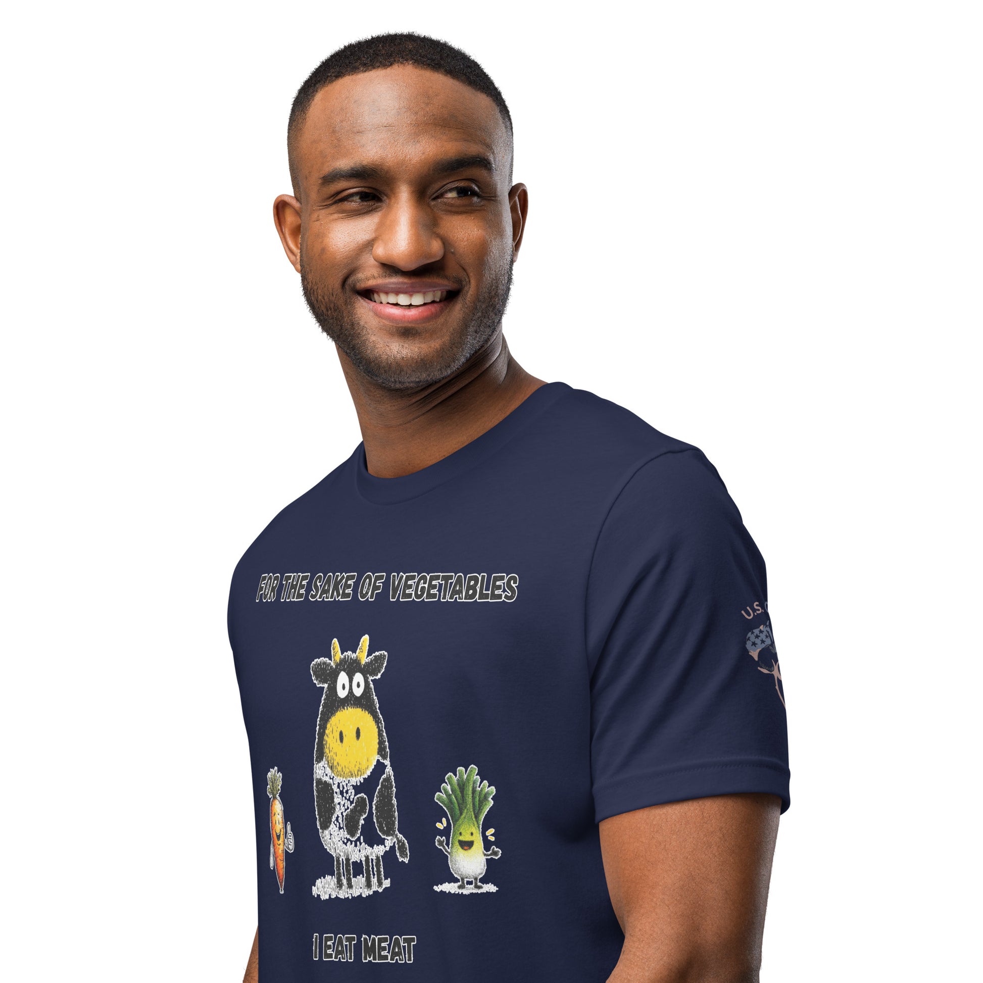 Product mockup. Smiling man wearing a navy blue T-shirt with the caption "FOR THE SAKE OF VEGETABLES I EAT MEAT" and illustrated veggie and cow characters.