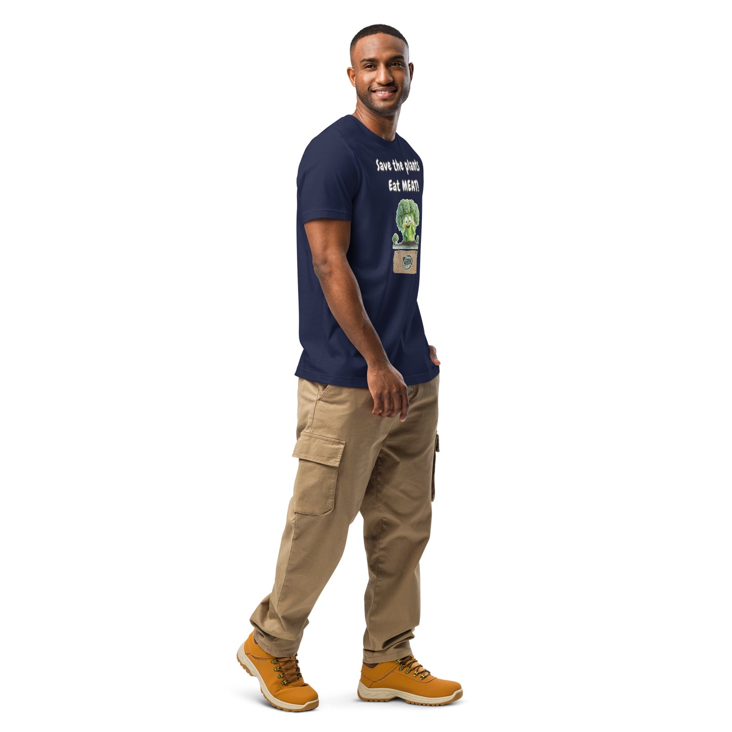 Product mockup. Side view of a navy blue T-shirt with a smiling woman, cartoon broccoli, and the phrase "Save the plants Eat MEAT!" shown on the chest.