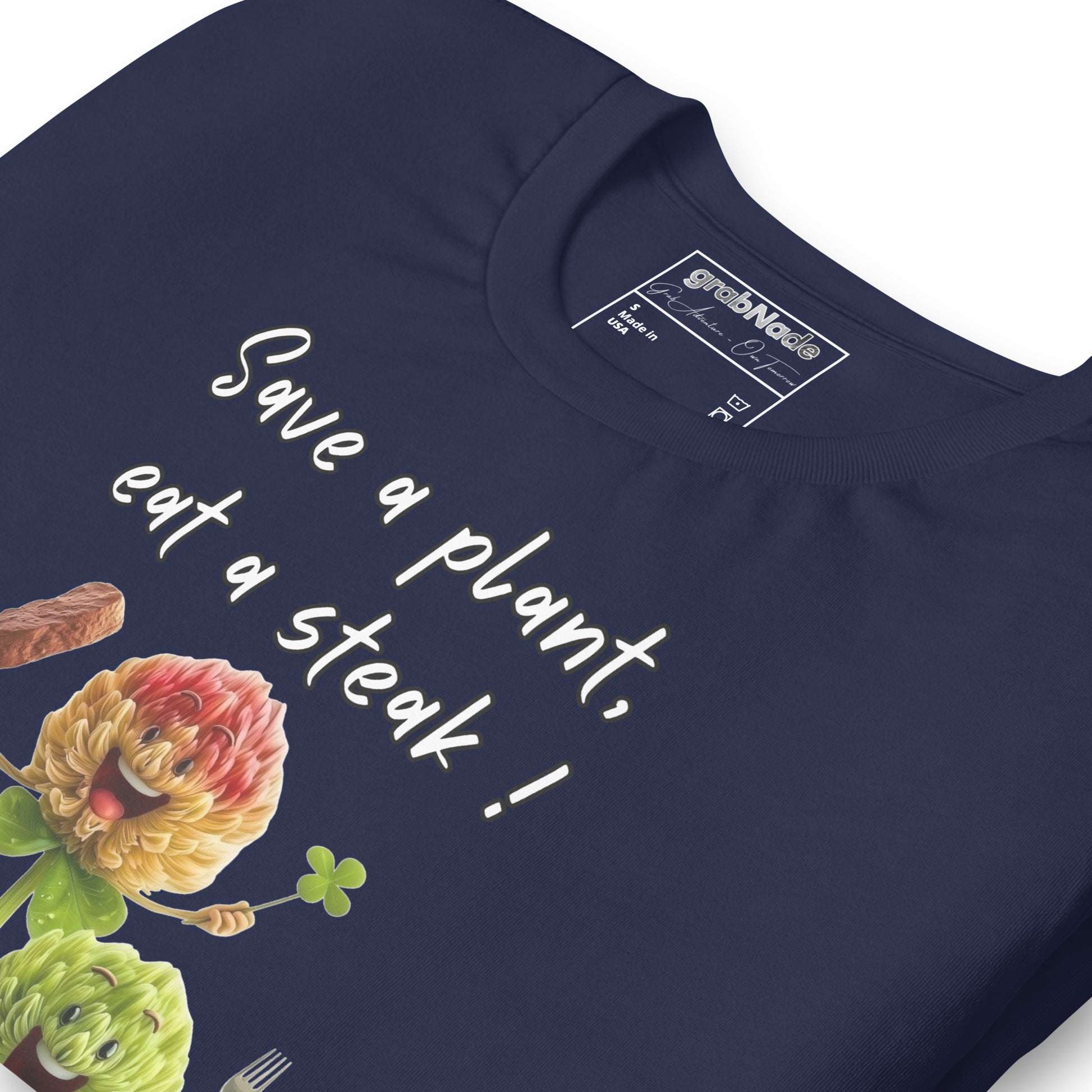 Product mockup. Close-up of navy blue T-shirt showing cartoon artichokes and the slogan "Save a plant, eat a steak!".