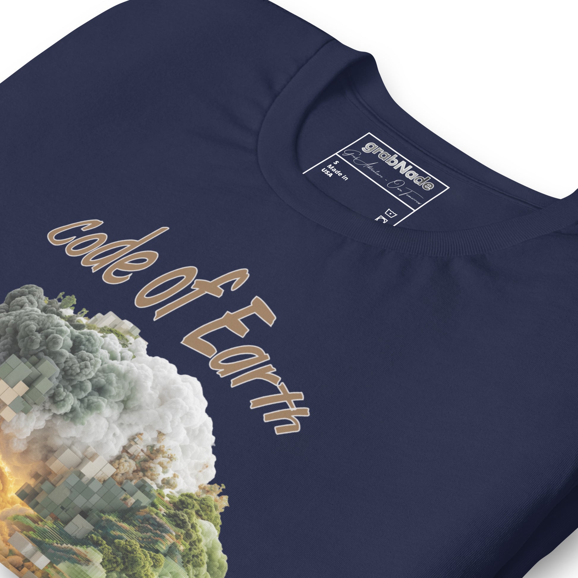 Product mockup. Close-up of navy blue T-shirt displaying a detailed "Code of Earth" nature and cloud graphic with pixelated accents.