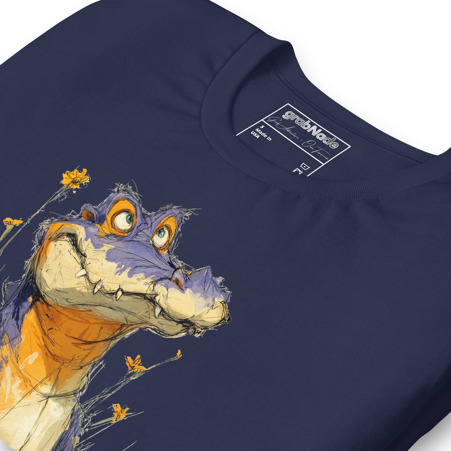 Product mockup. Close-up of navy blue T-shirt with a large cartoon purple alligator smiling among yellow flowers.
