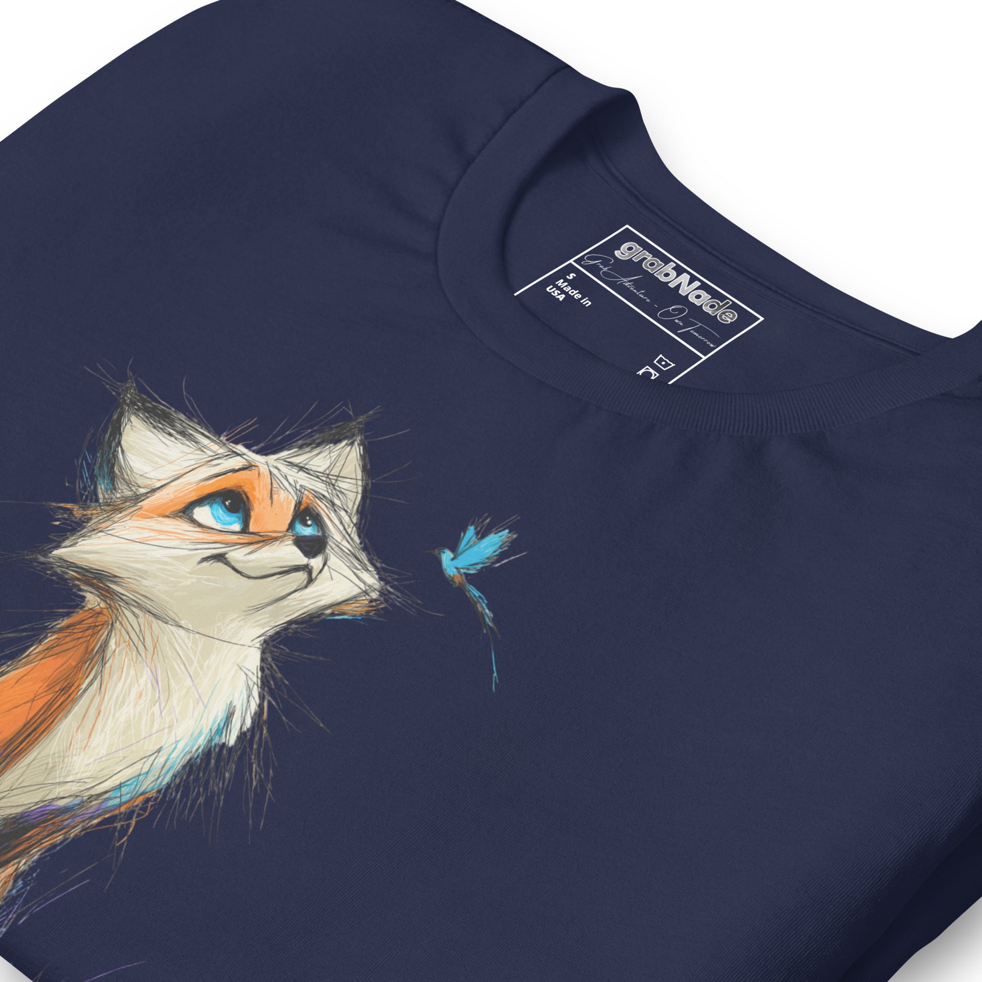 Product mockup. Close-up of navy blue T-shirt with a sketch-style orange fox looking up at a blue butterfly.