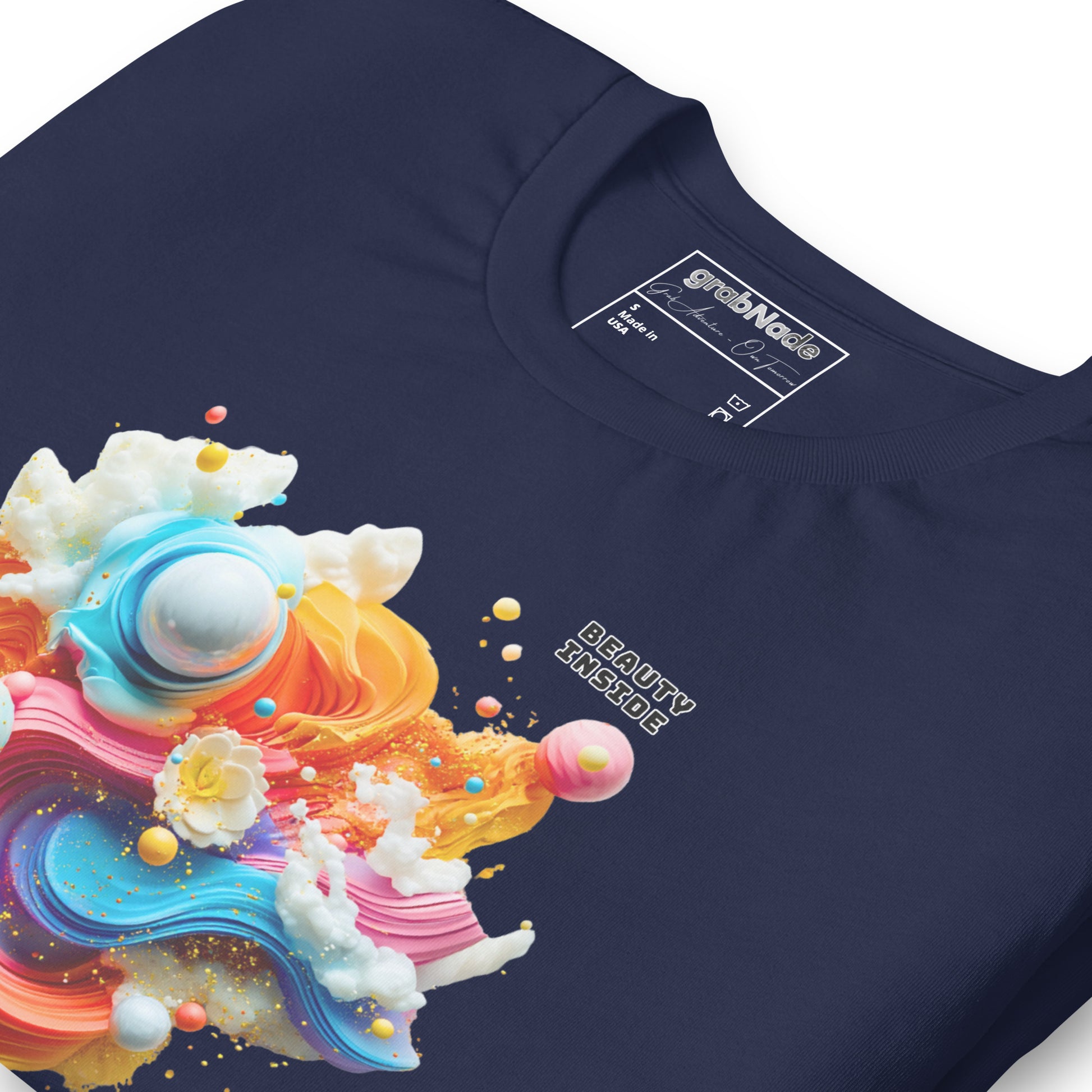 Product mockup. Close-up of navy blue T-shirt with a 3D abstract colorful paint swirl and planets, text "BEAUTY INSIDE."