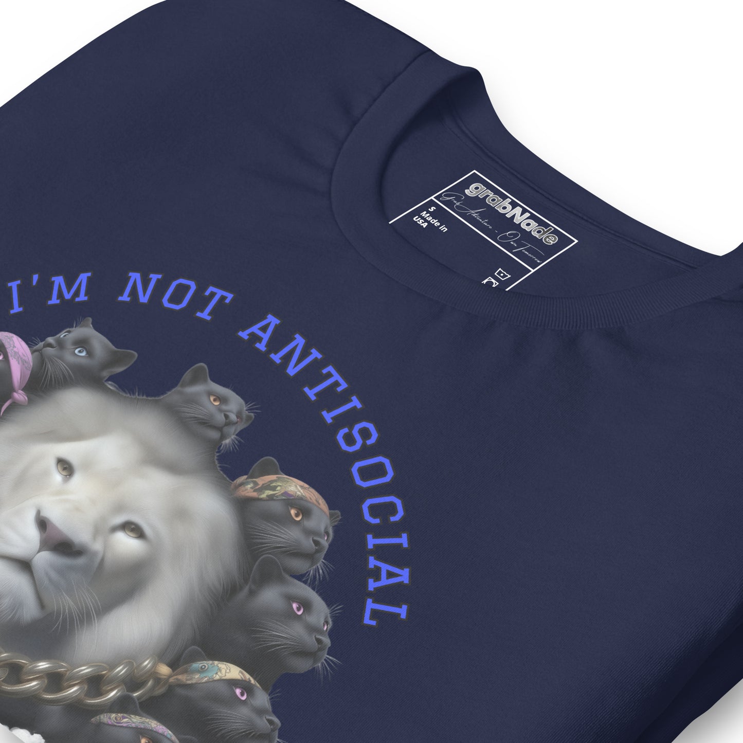Product mockup. Close-up of navy blue T-shirt featuring a white lion surrounded by black panther heads, gold chain, text "I'M NOT ANTISOCIAL."