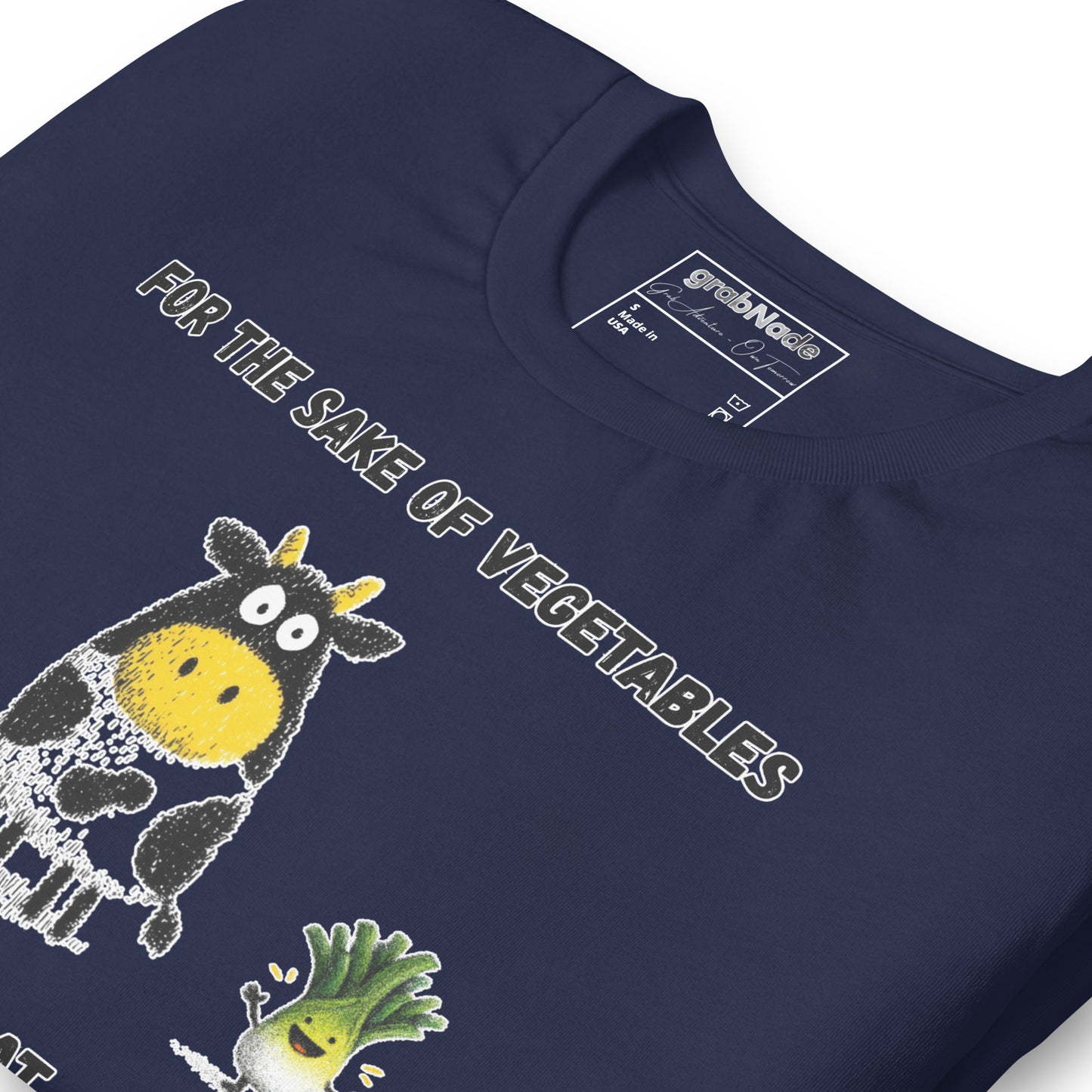 Product mockup. Close-up of navy blue T-shirt with smiling vegetable characters and cow, text "FOR THE SAKE OF VEGETABLES I EAT MEAT."