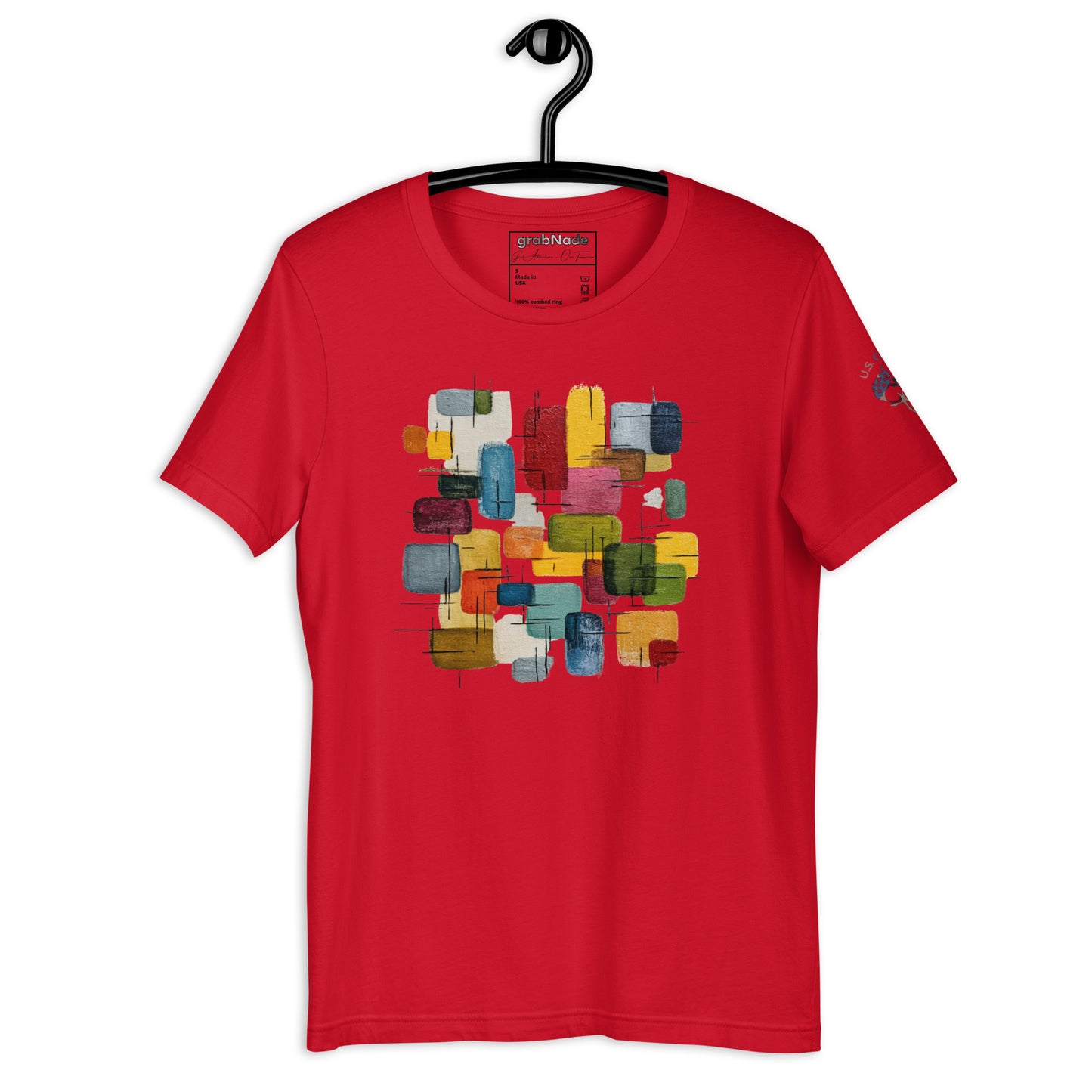 Product mockup. Red T-shirt, folded, showing large, abstract, multicolor painted block print on the front.