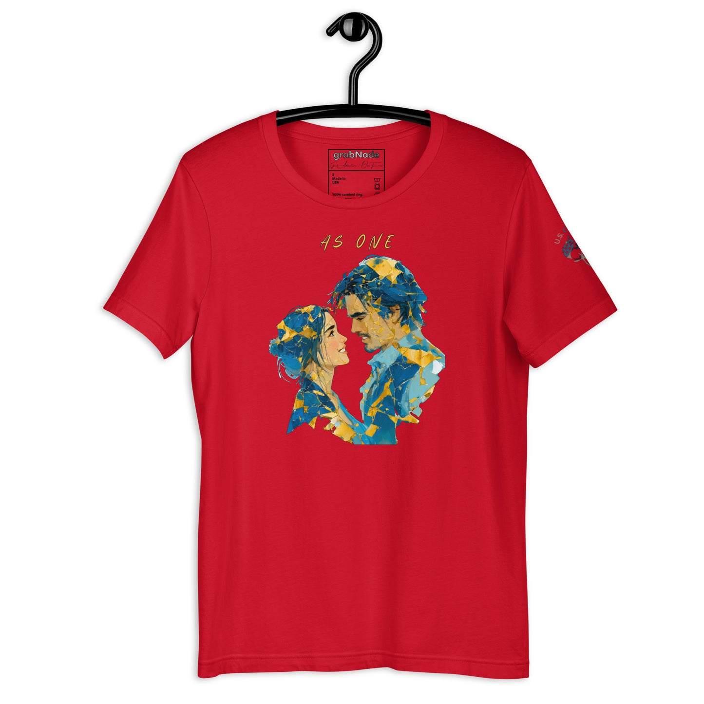 Product mockup. Folded red T-shirt showing a geometric blue and yellow collage of two people facing each other, "AS ONE" above.