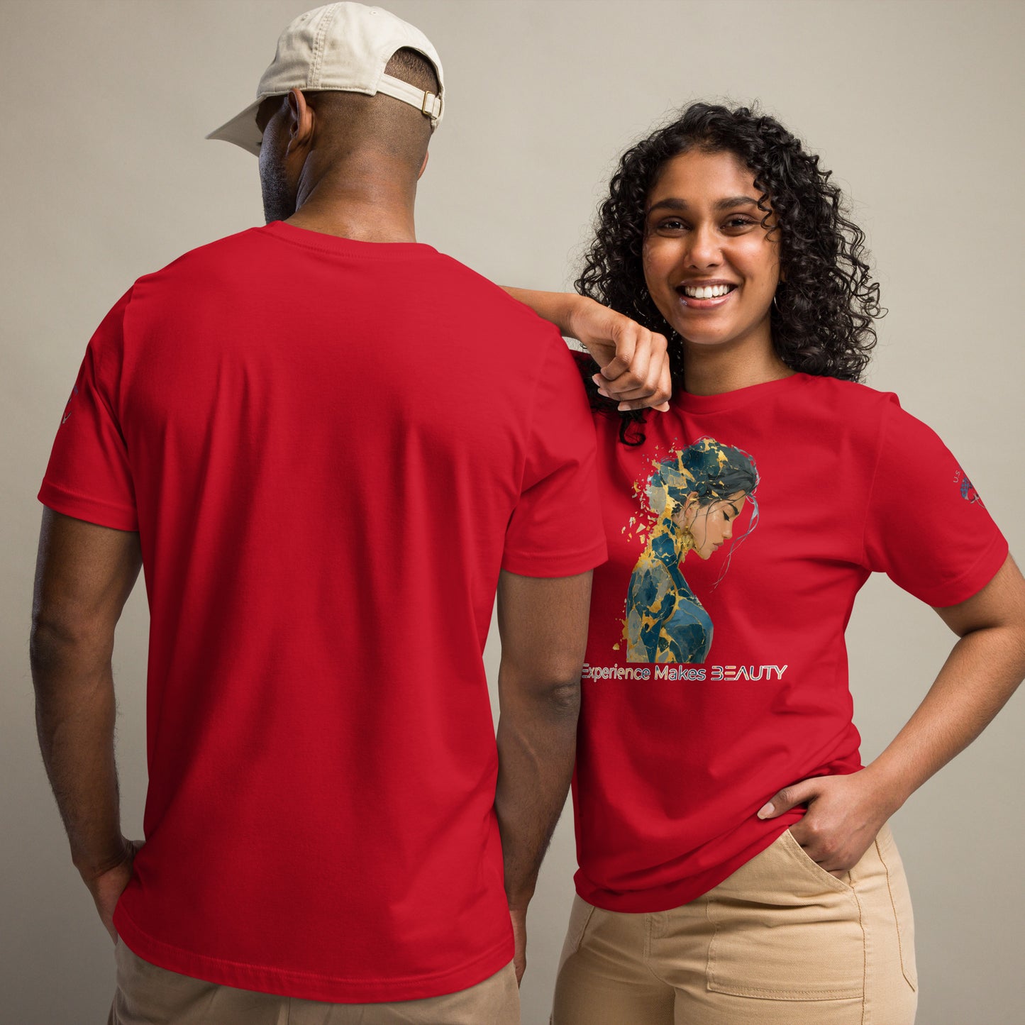 Product mockup. Man and woman; woman in red T-shirt with abstract painterly portrait and "Experience Makes BEAUTY" text, man in plain red shirt from the back.