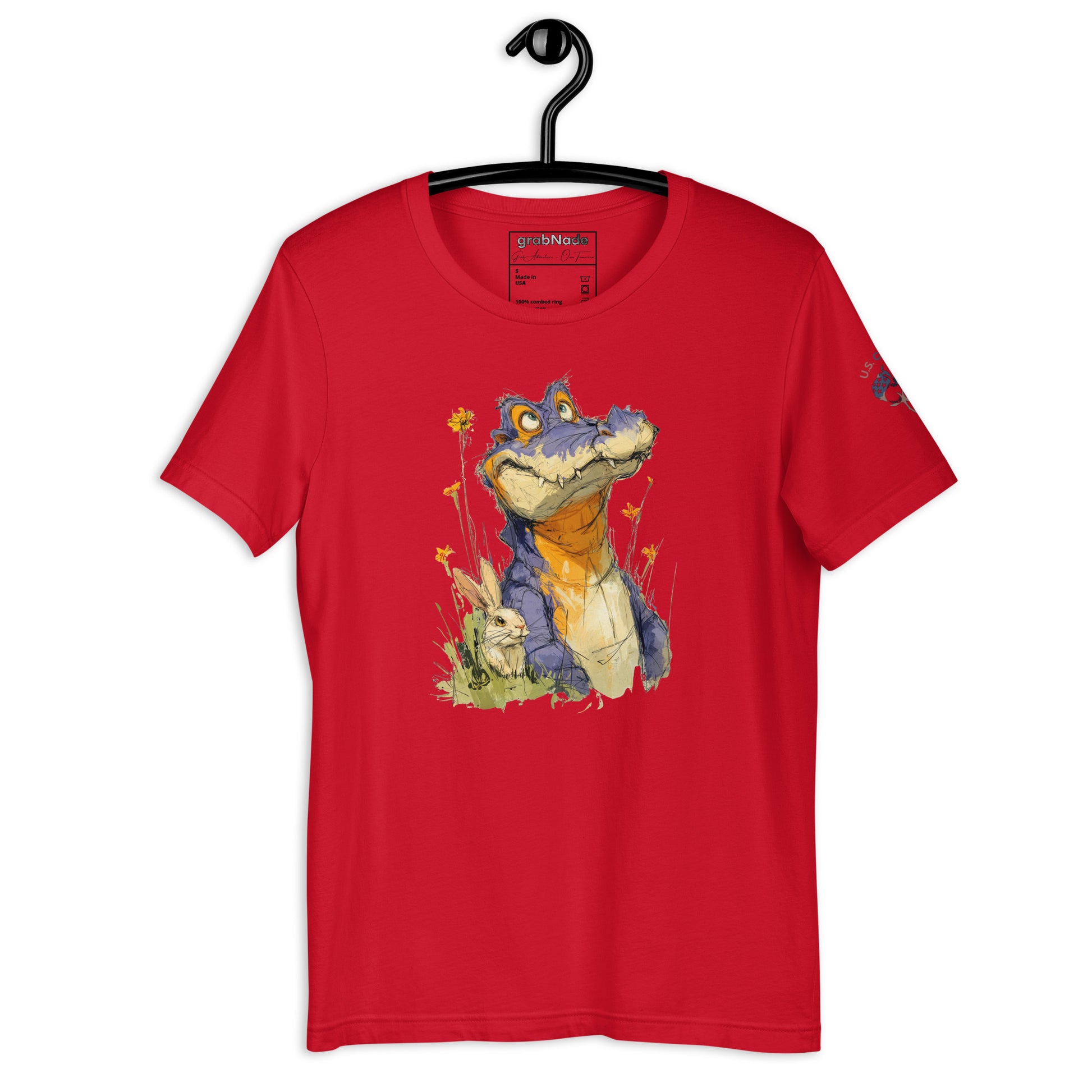 Product mockup. Red T-shirt on hanger with illustrated blue/yellow cartoon alligator beside bunny amid yellow wildflowers.