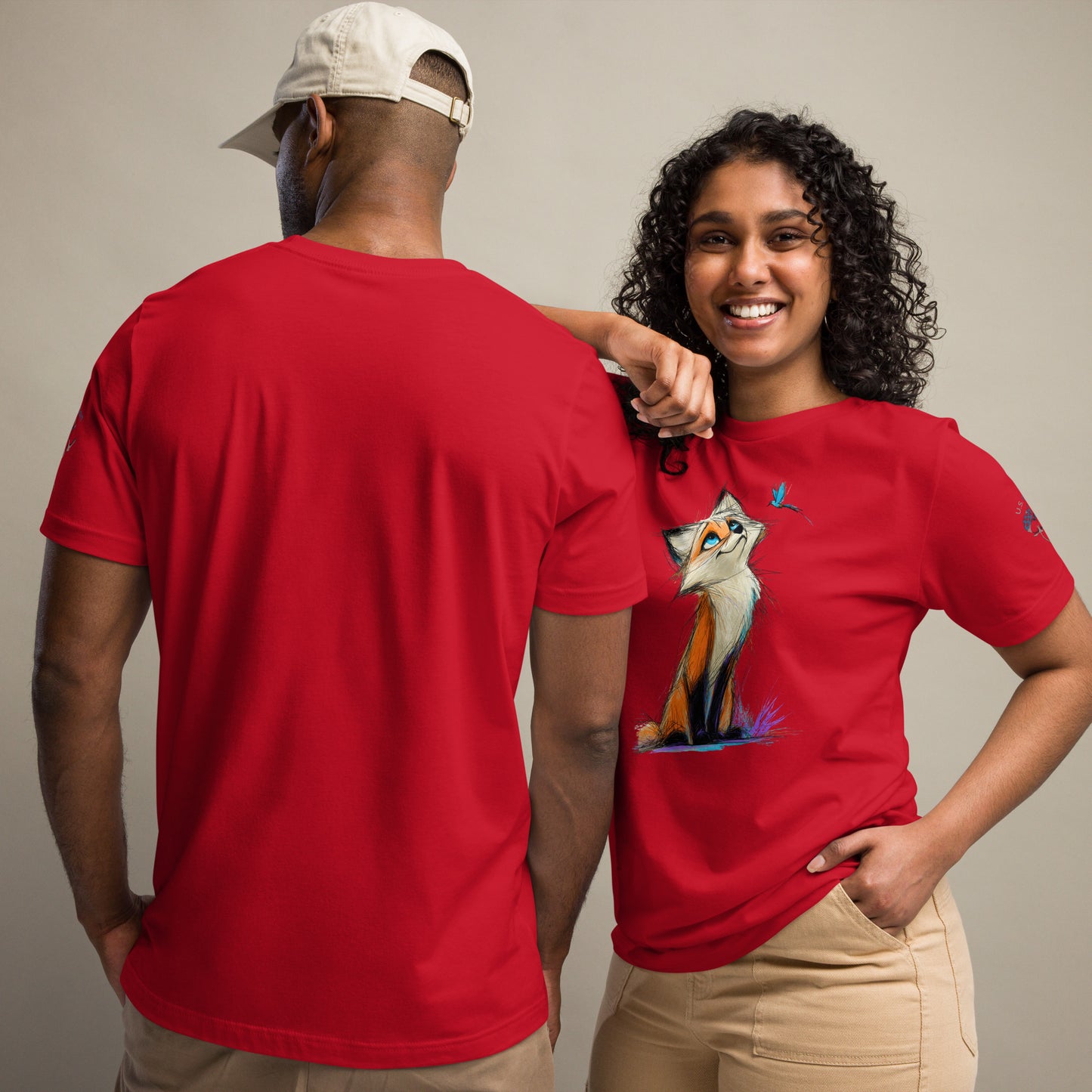 Product mockup. Man and woman; woman in red T-shirt with illustrated fox and blue butterfly, man in plain red shirt back view.