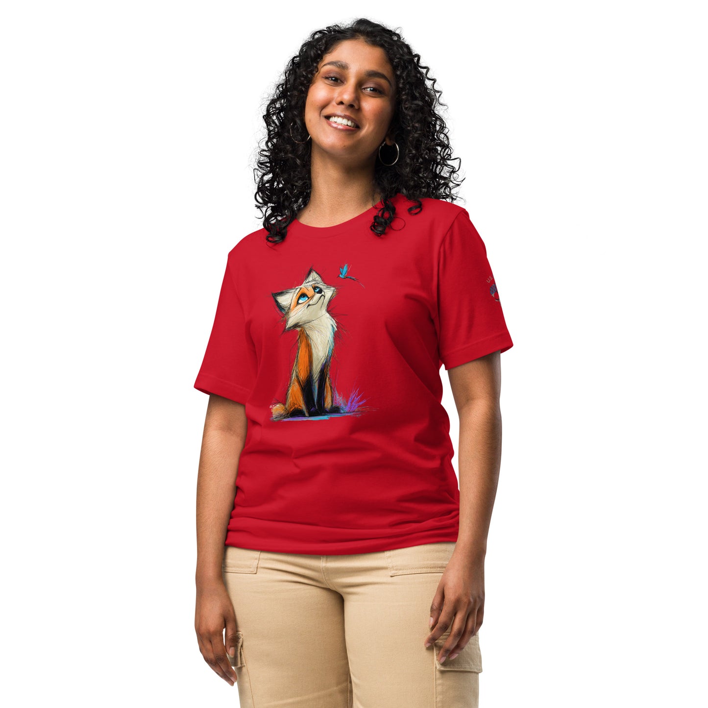 Product mockup. Woman in red T-shirt with cheerful, hand-drawn fox seated on grass, glancing up at a blue butterfly.