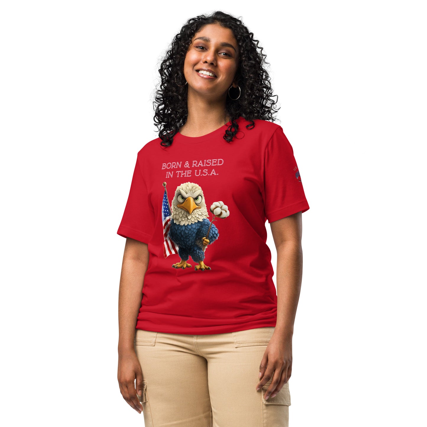Product mockup. Premium red cotton t-shirt worn by a woman; front view highlights large "Born & Raised in the U.S.A." graphic with eagle, American flag, and cotton stem. Classic fit.