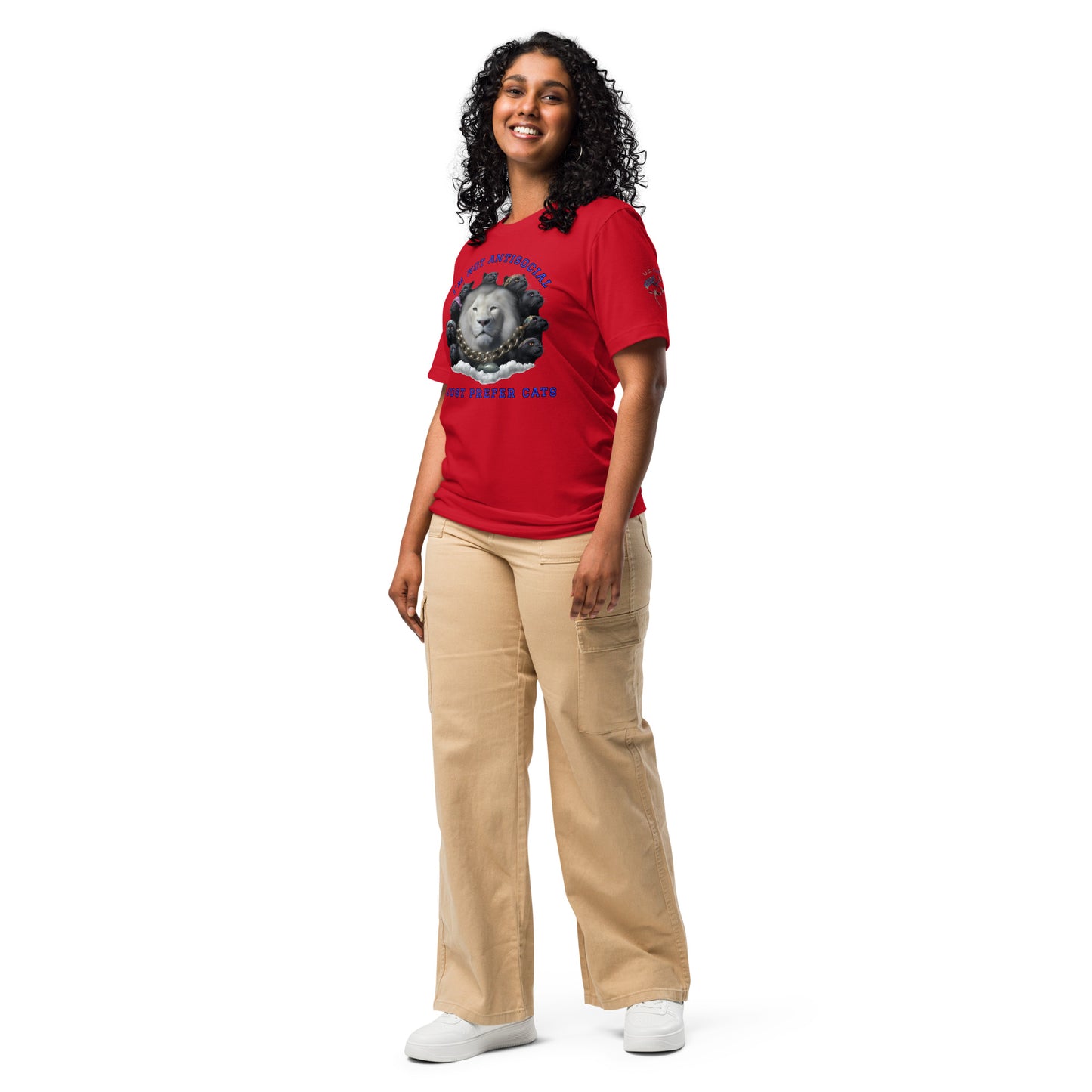 Product mockup. A woman wearing beige pants and a red T-shirt featuring a group of black dogs encircling a square, with the words "I’m Not Antisocial" above, full-body pose.