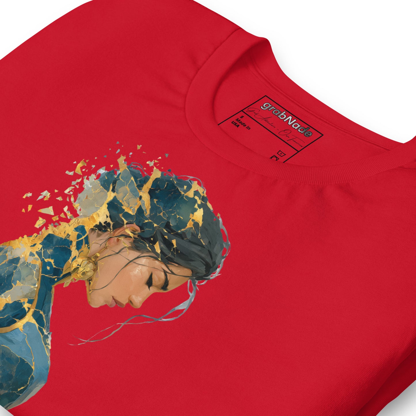 Product mockup. Red T-shirt, zoomed in, stylized cracked sculpture of a person; artistic gold and blue split effect.