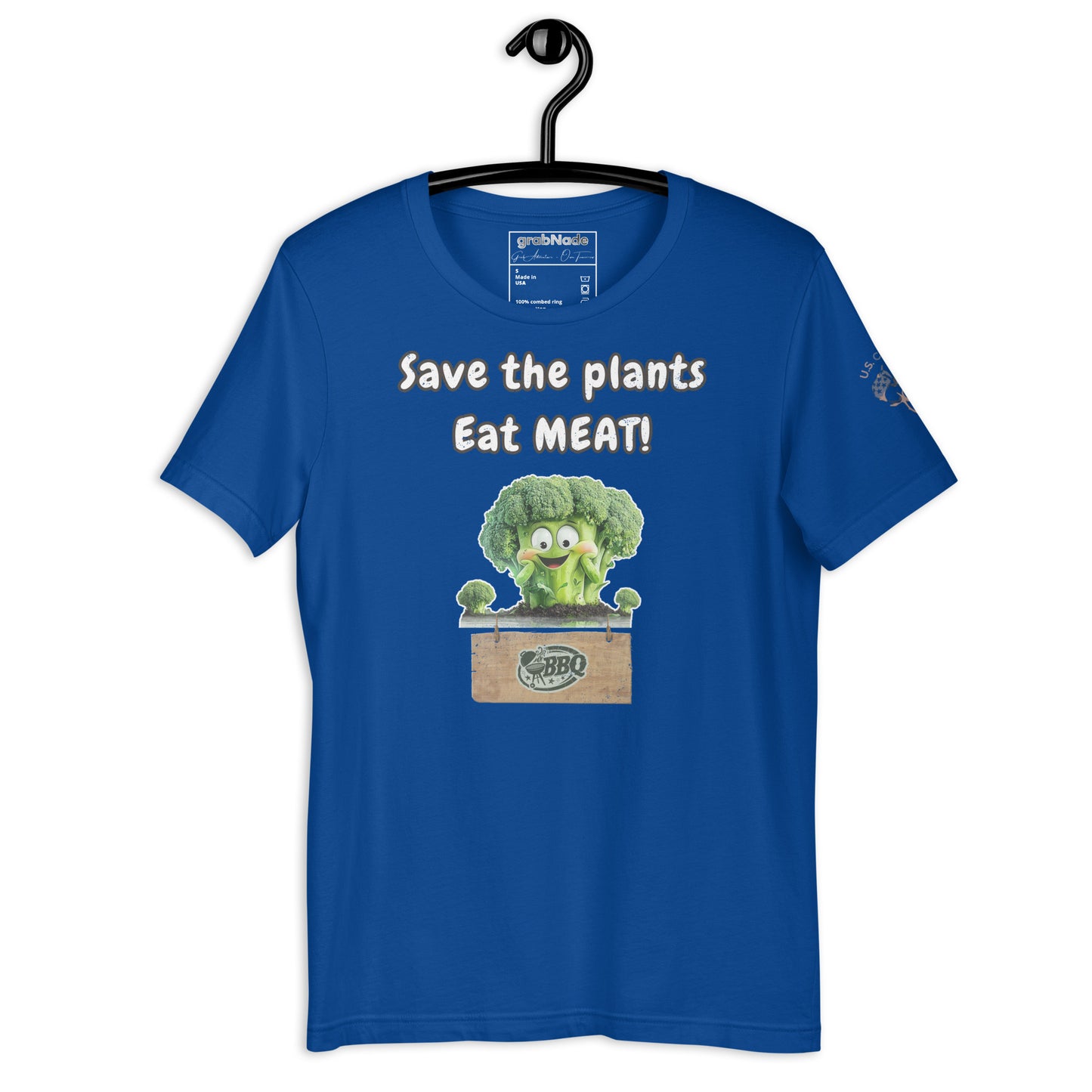 Product mockup. Royal blue T-shirt on a hanger featuring a smiling cartoon broccoli in a wooden crate and the words “Save the plants Eat MEAT!”