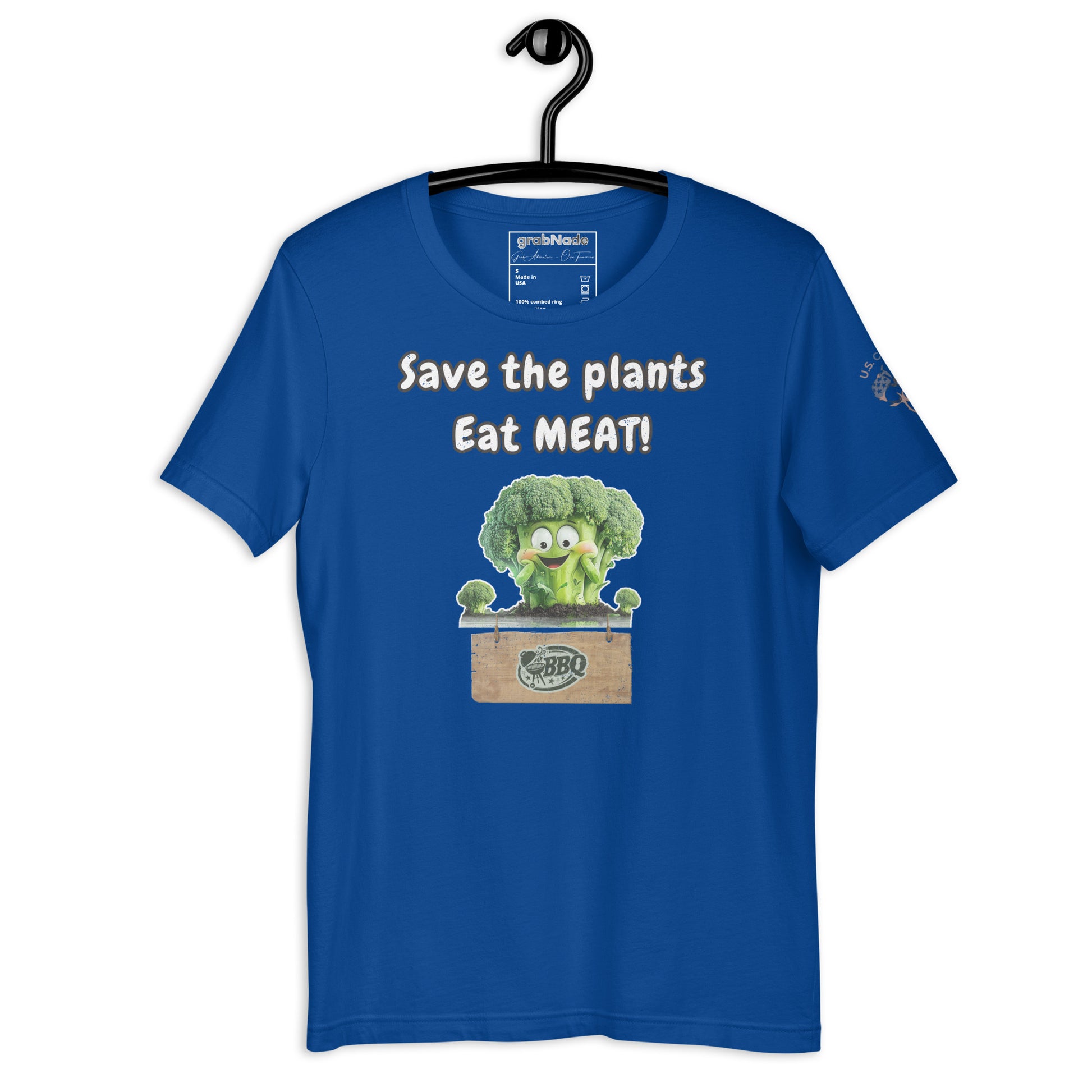 Product mockup. Royal blue T-shirt on a hanger featuring a smiling cartoon broccoli in a wooden crate and the words “Save the plants Eat MEAT!”