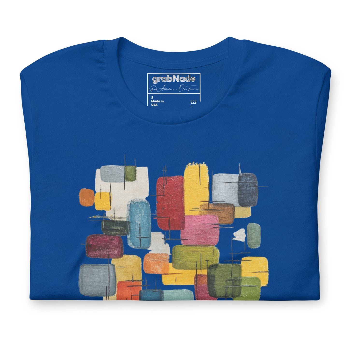 Product mockup. Folded royal blue T-shirt displaying a vibrant geometric abstract print with overlapping rectangles in blue, yellow, red, and green.