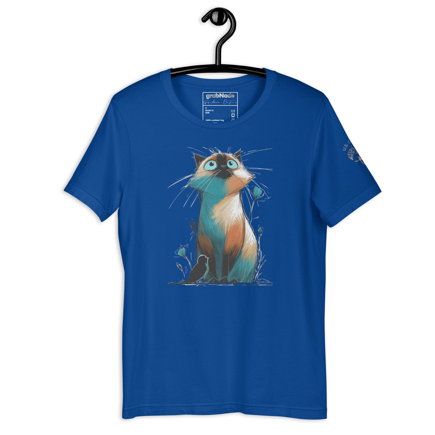 Product mockup. Blue T-shirt on hanger, showing stylized cartoon cat with tall ears and wide eyes, sitting with whimsical grass and flowers.