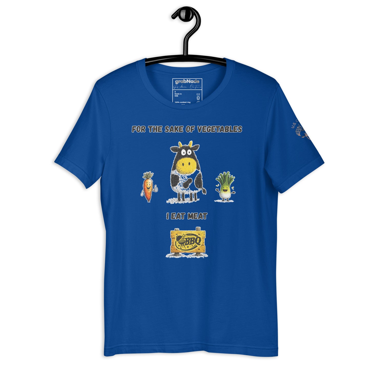 Product mockup. Blue T-shirt on a hanger decorated with a cartoon cow and smiling vegetables, text reads “For the sake of vegetables I eat meat” above a BBQ sign.