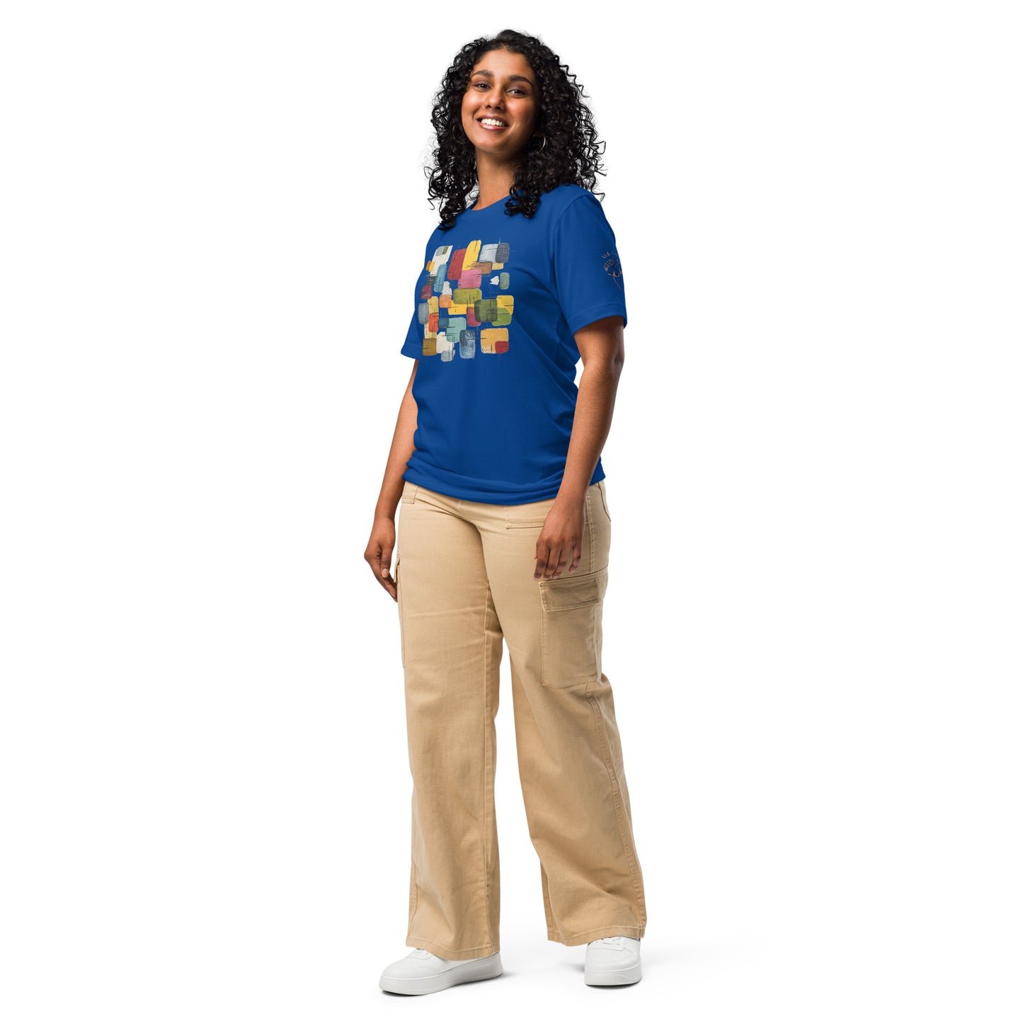 Product mockup. Blue T-shirt left front with “U.S. Cotton” logo on sleeve; multicolor stacked block print partly visible on the chest.