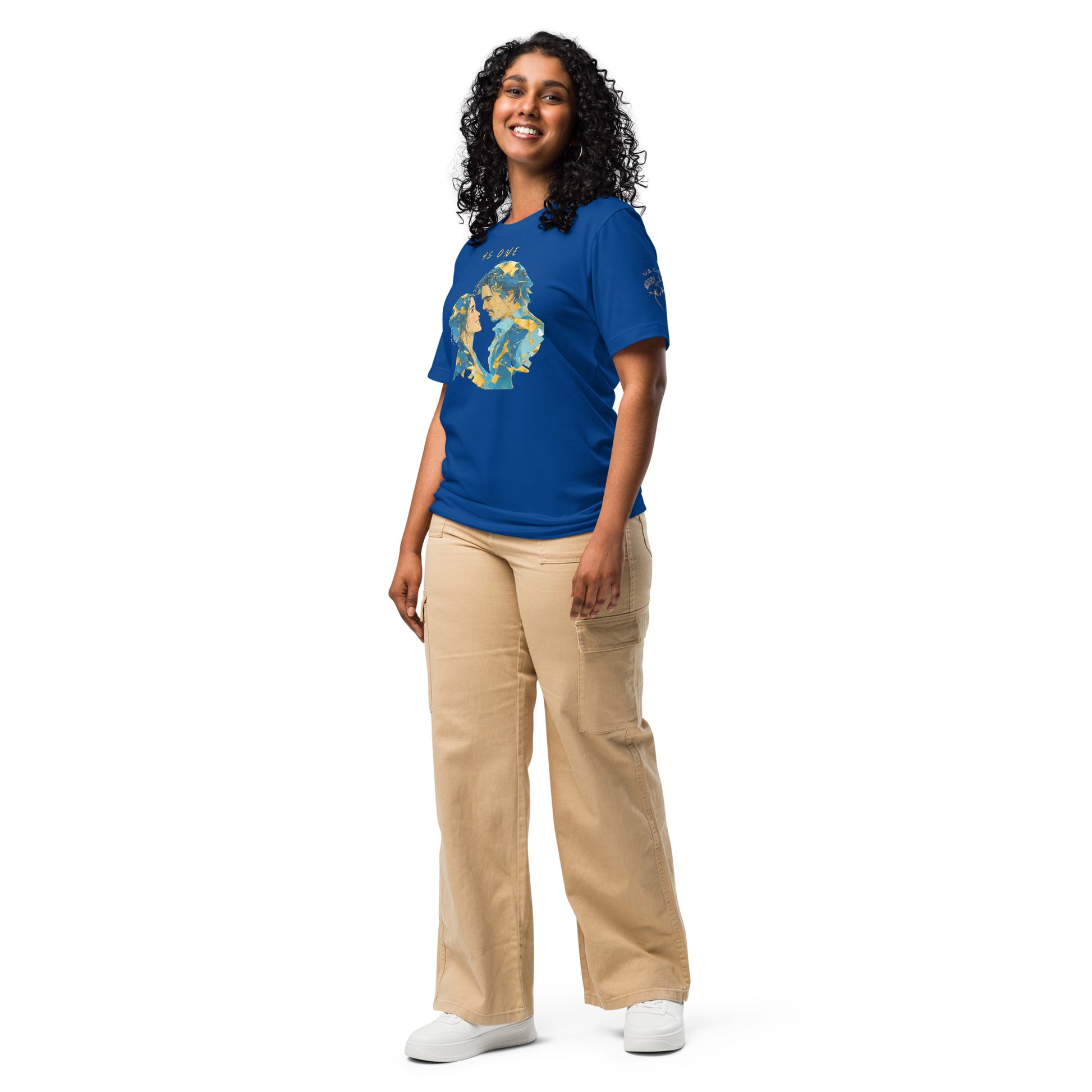 Product mockup. Smiling women wearing a blue T-shirt, left front view, displaying a gold, blue, and yellow illustration of two faces forming a heart with the words “AS ONE” above,