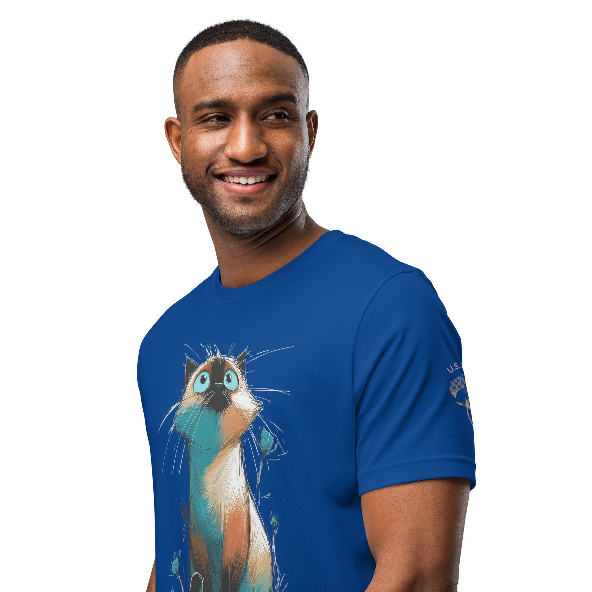 Product mockup. Blue T-shirt, left front, large graphic of an illustrated cat in blue, tan, and gold, looking upward amid blue and green plants, close-up from the torso up.