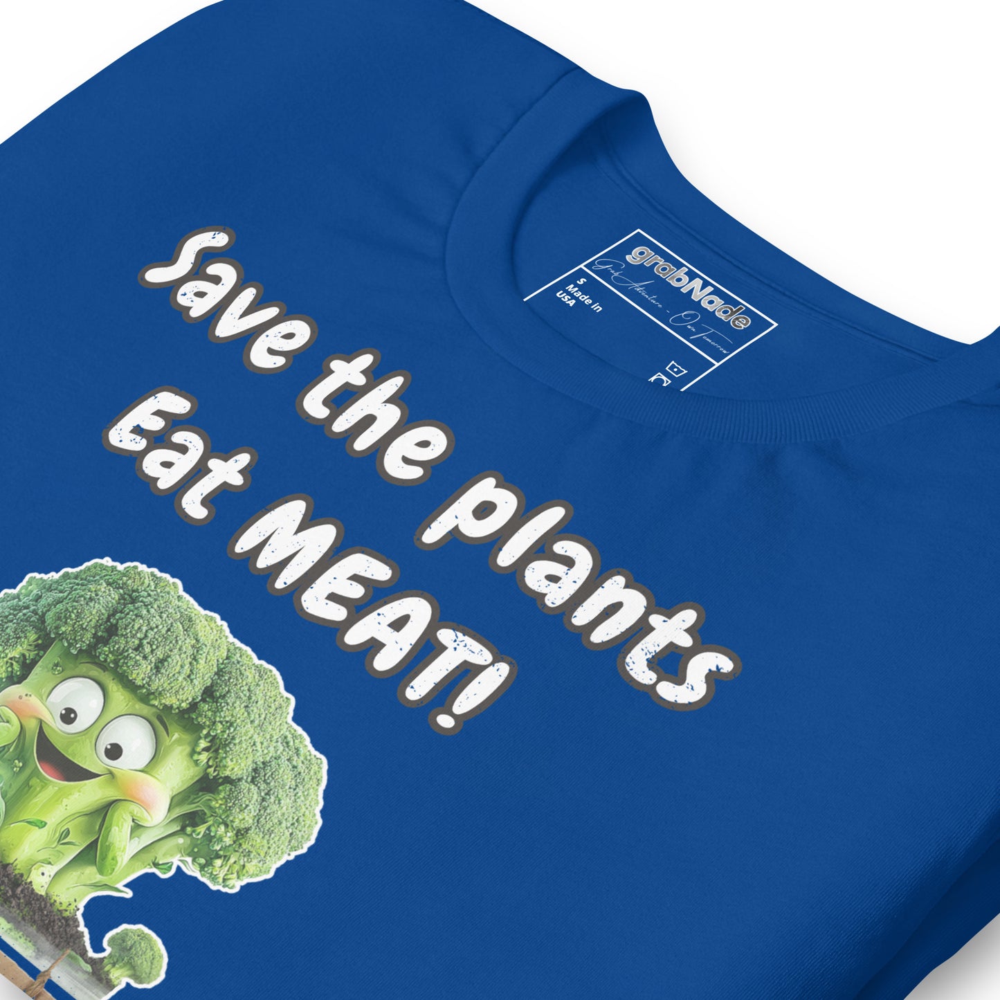 Product mockup. Blue T-shirt, zoomed in, displaying cheerful cartoon broccoli and text: “Save the plants, Eat MEAT!”