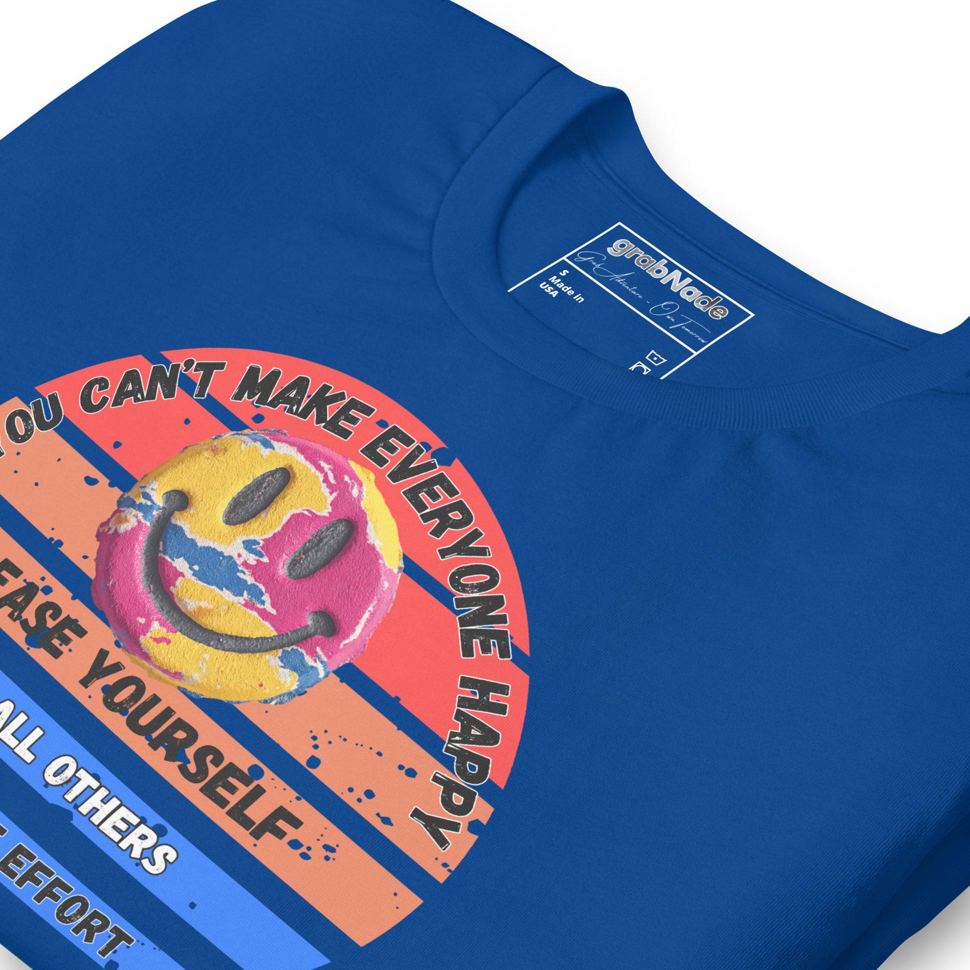 Product mockup. Blue T-shirt, zoomed in, vibrant paint-splattered smiley face, text: “YOU CAN’T MAKE EVERYONE HAPPY… PLEASE YOURSELF. ALL OTHERS WORHT THE EFFORT.”