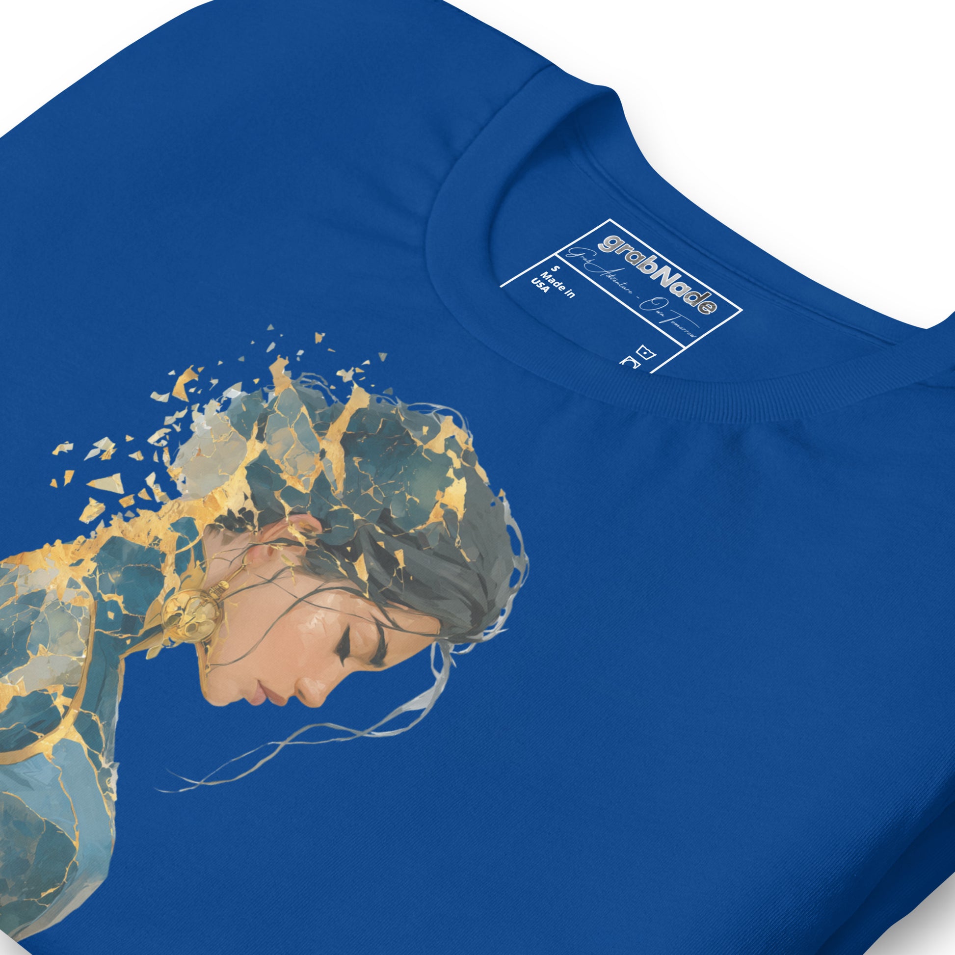 Product mockup. Blue T-shirt, zoomed in, stylized cracked sculpture of a person; artistic gold and blue split effect.