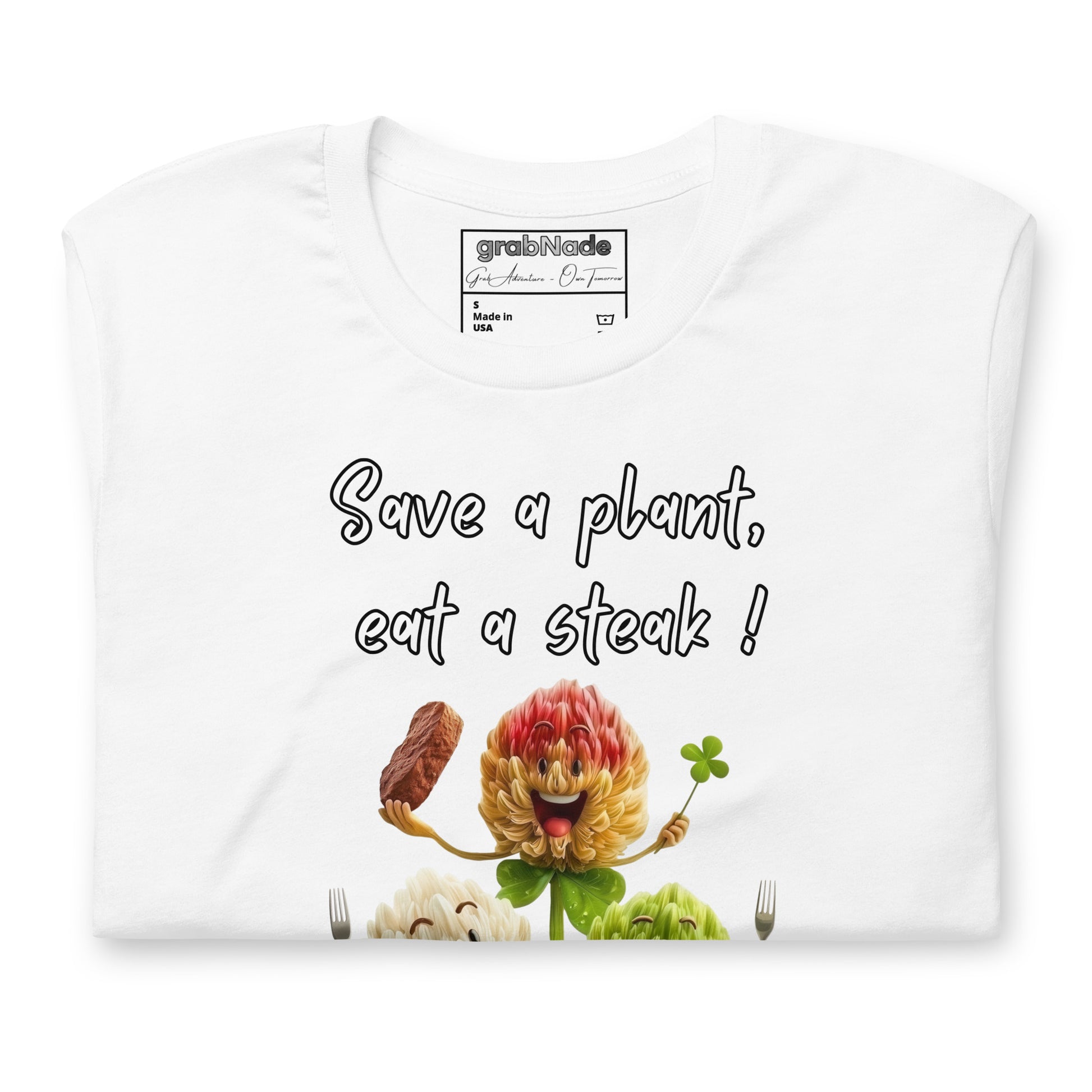 Product mockup. Folded white T-shirt with cartoon flowers, forks, steak, and text: “Save a plant, eat a steak!”