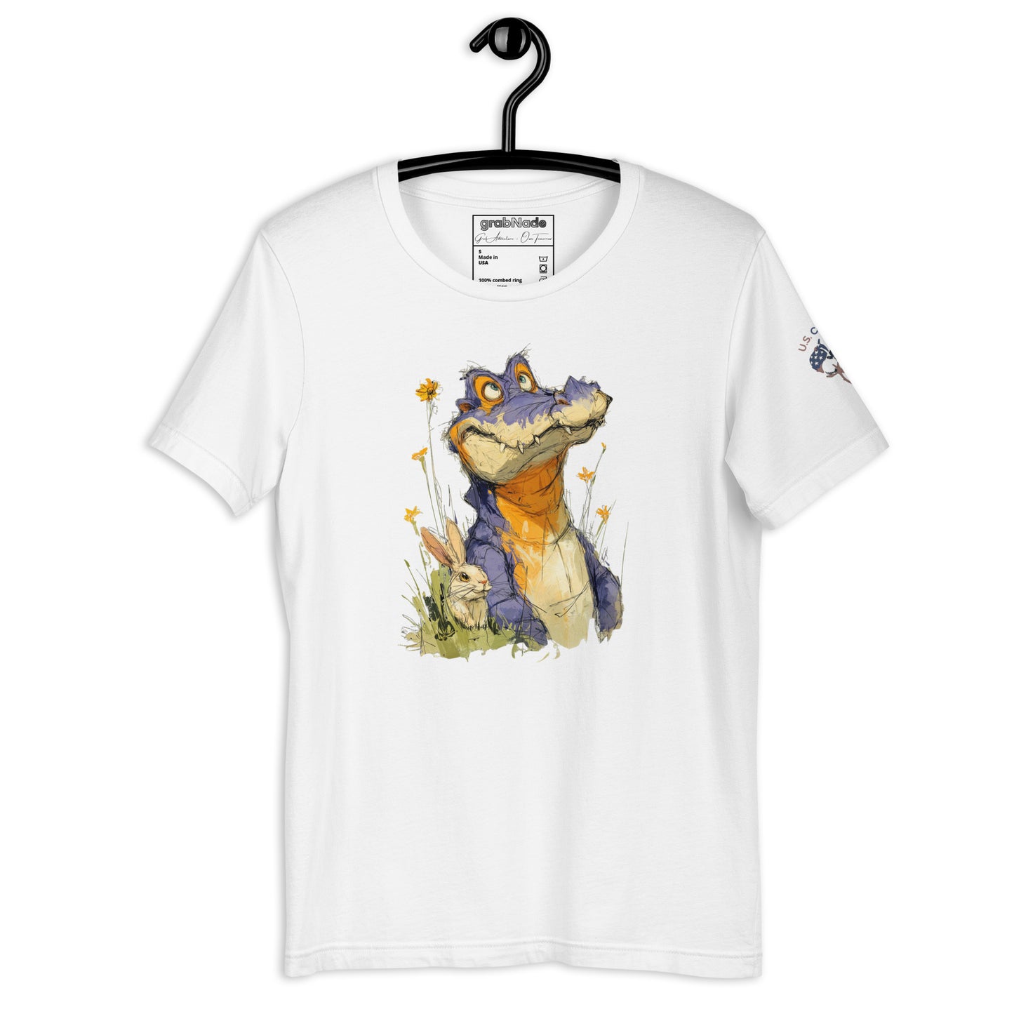 Product mockup. White T-shirt on hanger featuring colorful crocodile artwork among yellow flowers and greenery.