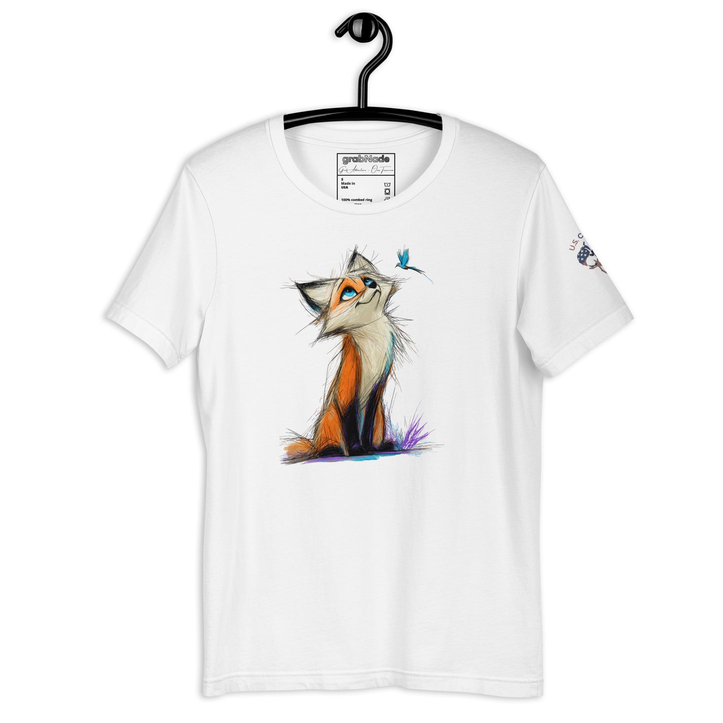 Product mockup. White T-shirt on hanger featuring a stylized orange fox illustration with a blue bird, sitting in purple grass.