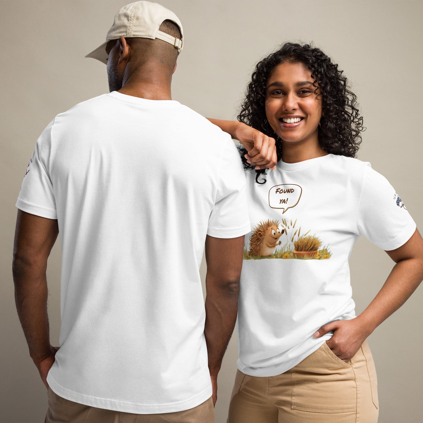 Product mockup. Man showing back of plain white T-shirt; woman in “Found ya!” T-shirt with smiling cartoon hedgehog in field.