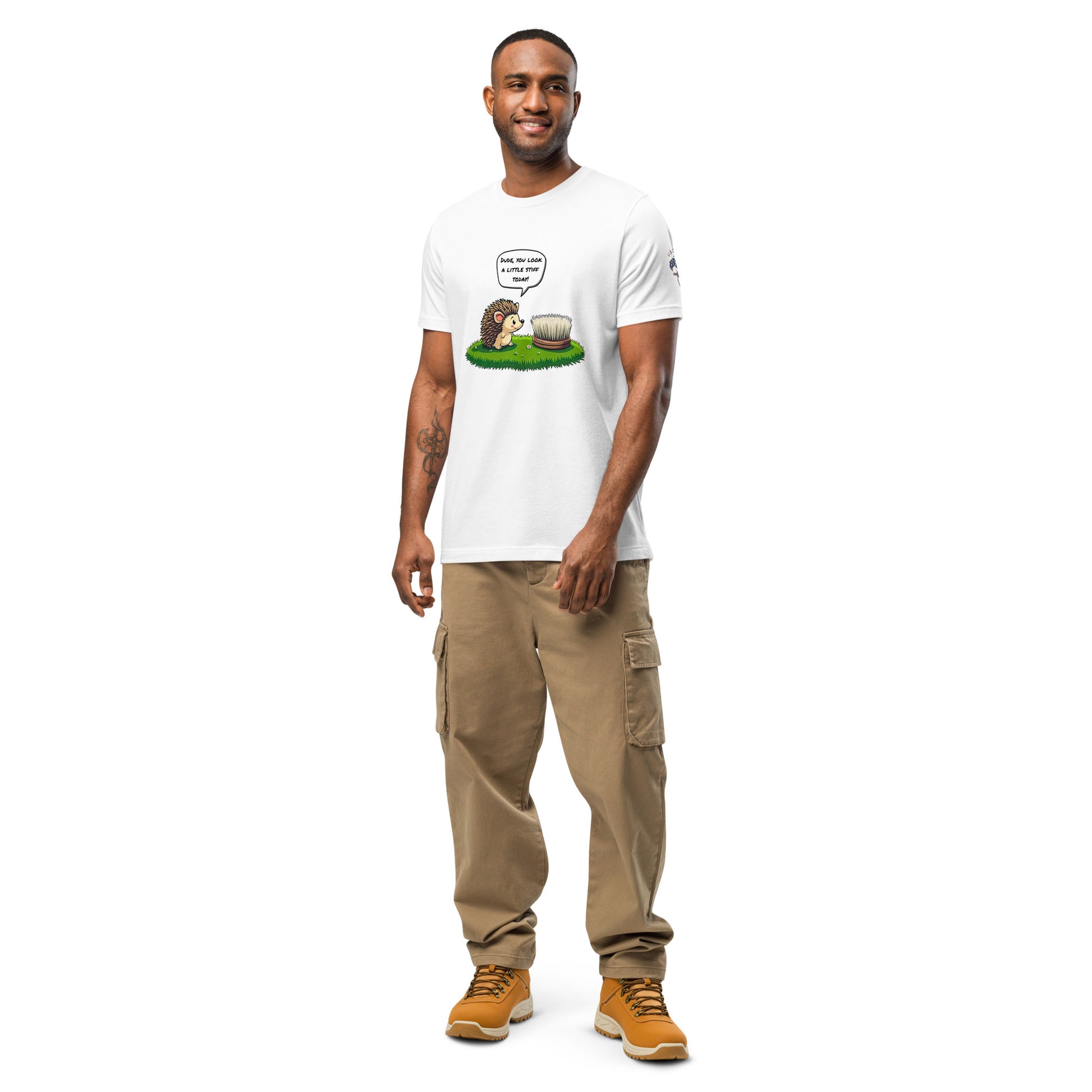 Product mockup. Man in white T-shirt, cartoon hedgehog talking to a stiff brush in grass: "DUDE, YOU LOOK A LITTLE STIFF TODAY!"