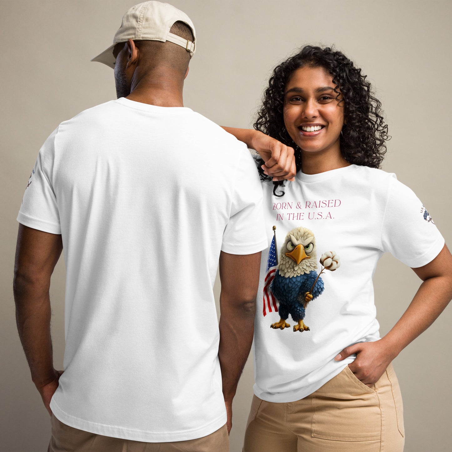 Product mockup. Man and woman in white shirts; woman in beige pants and t-shirt with a bald eagle, American flag, and cotton boll, text: “BORN & RAISED IN THE U.S.A.”, man with plain white view.