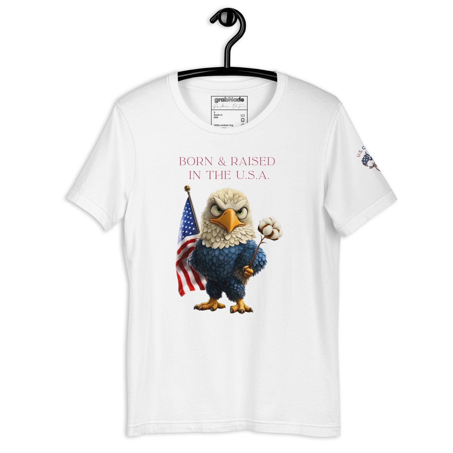 Product mockup. White T-shirt on hanger with a cartoon bald eagle, American flag, and cotton boll below the text: "Born & raised in the U.S.A."