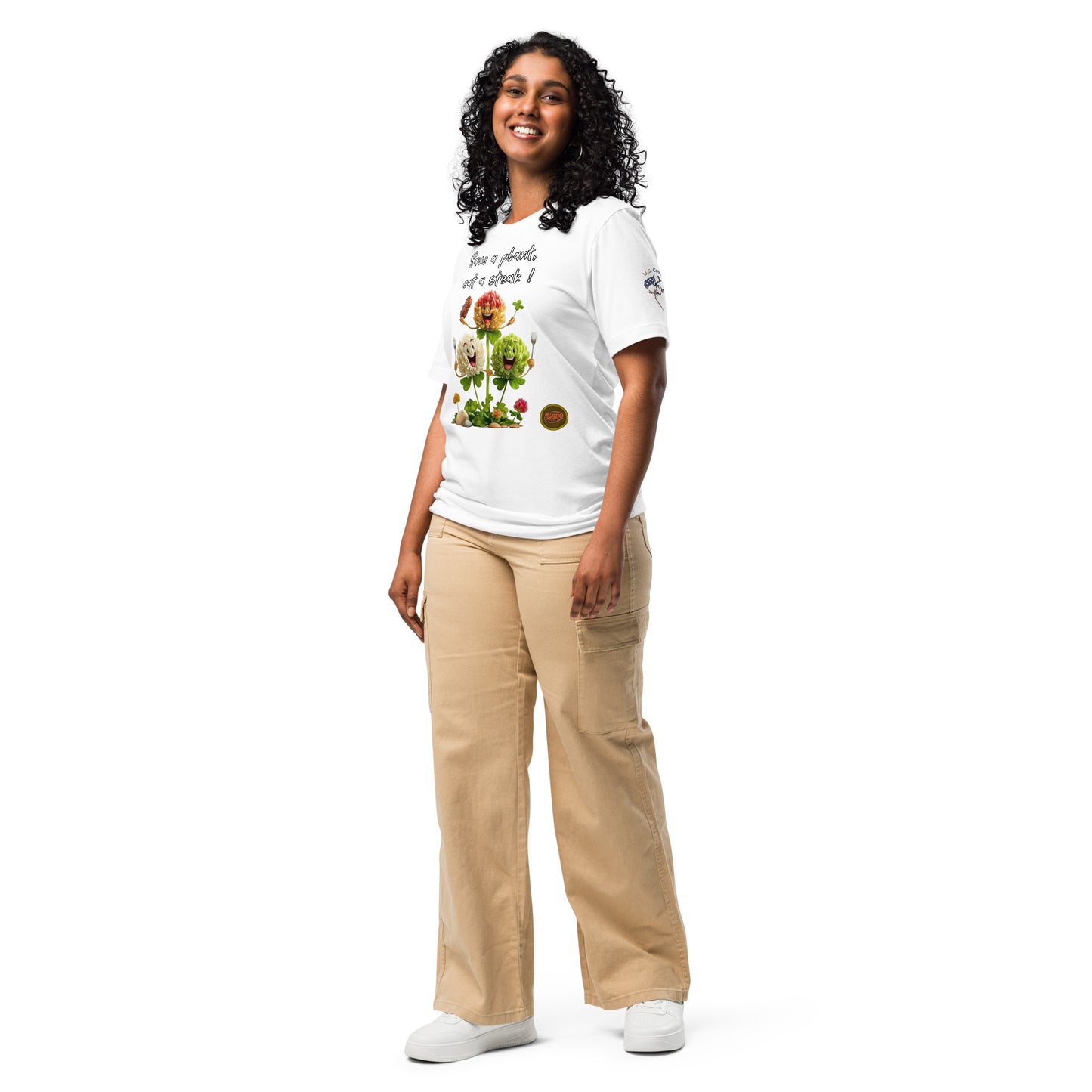 Product mockup. Woman in white T-shirt, "Save a plant, eat a steak!" text with cartoon leafy vegetables and utensils, "U.S. Cotton" sleeve logo.