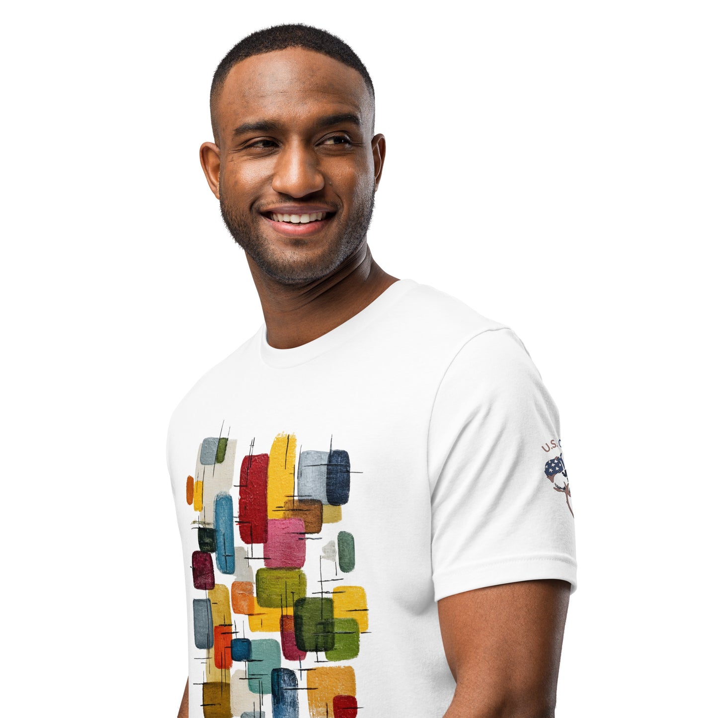 Product mockup. Man wearing a white T-shirt with colorful, abstract rectangular graphic pattern, "U.S. Cotton" boll logo visible on the right sleeve, close-up from the torso up.