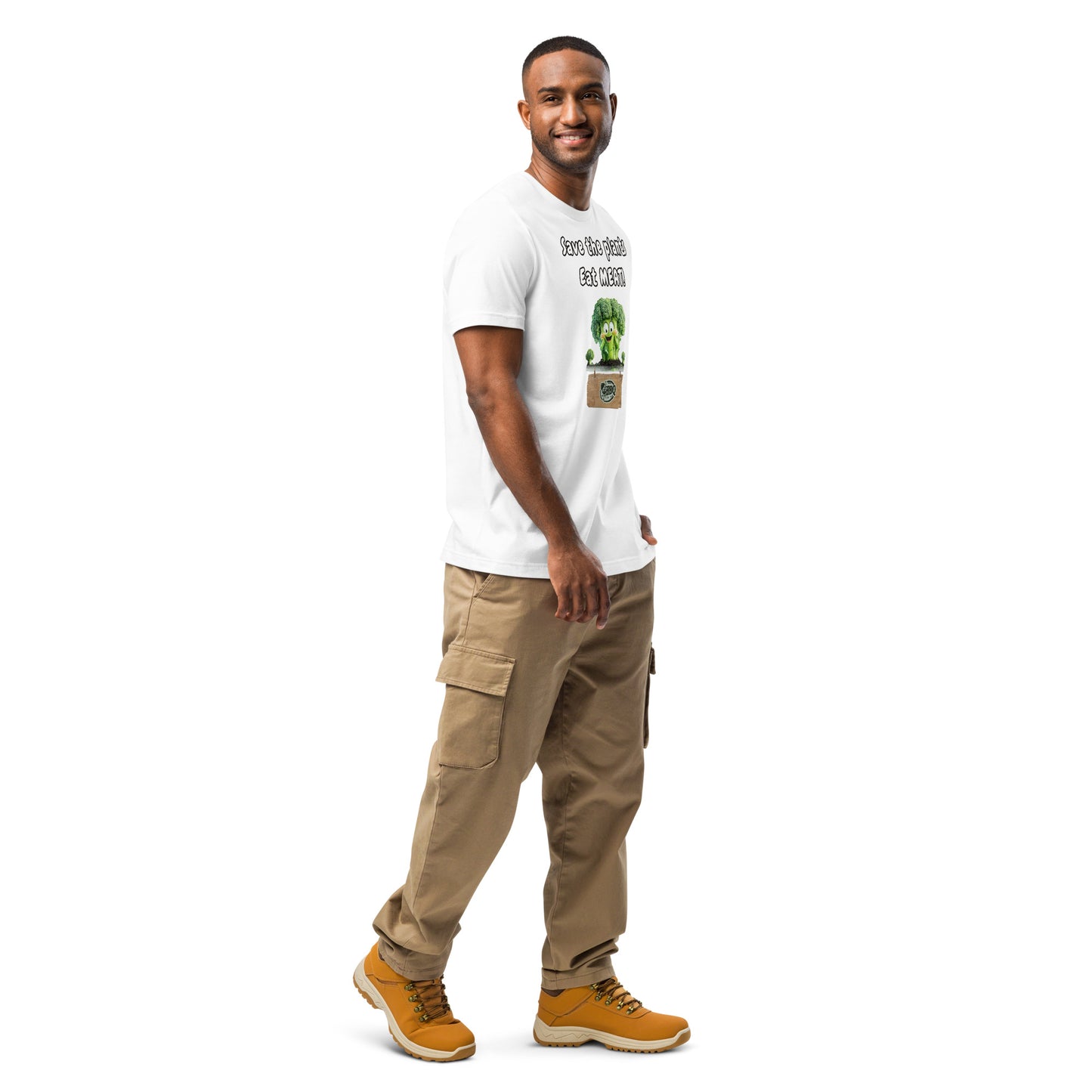 Product mockup. White T-shirt, right front, with “Save the plants, Eat MEAT!” above a happy cartoon broccoli in grass.