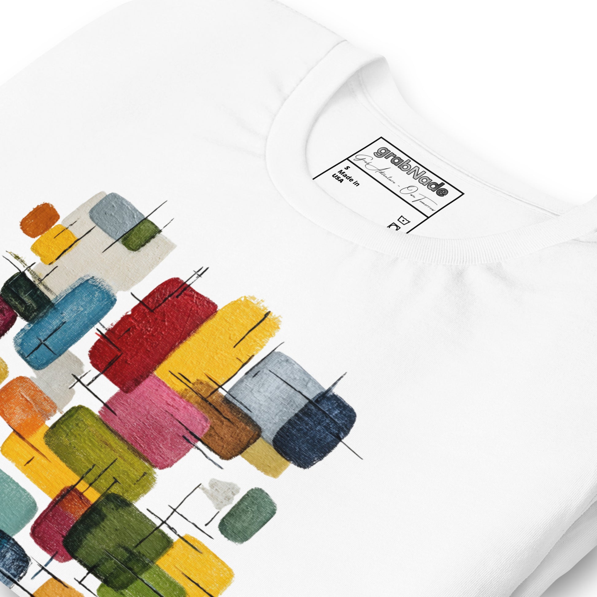 Product mockup. White T-shirt, zoomed in, showing abstract blocks in various colors (yellow, red, blue, green, pink).
