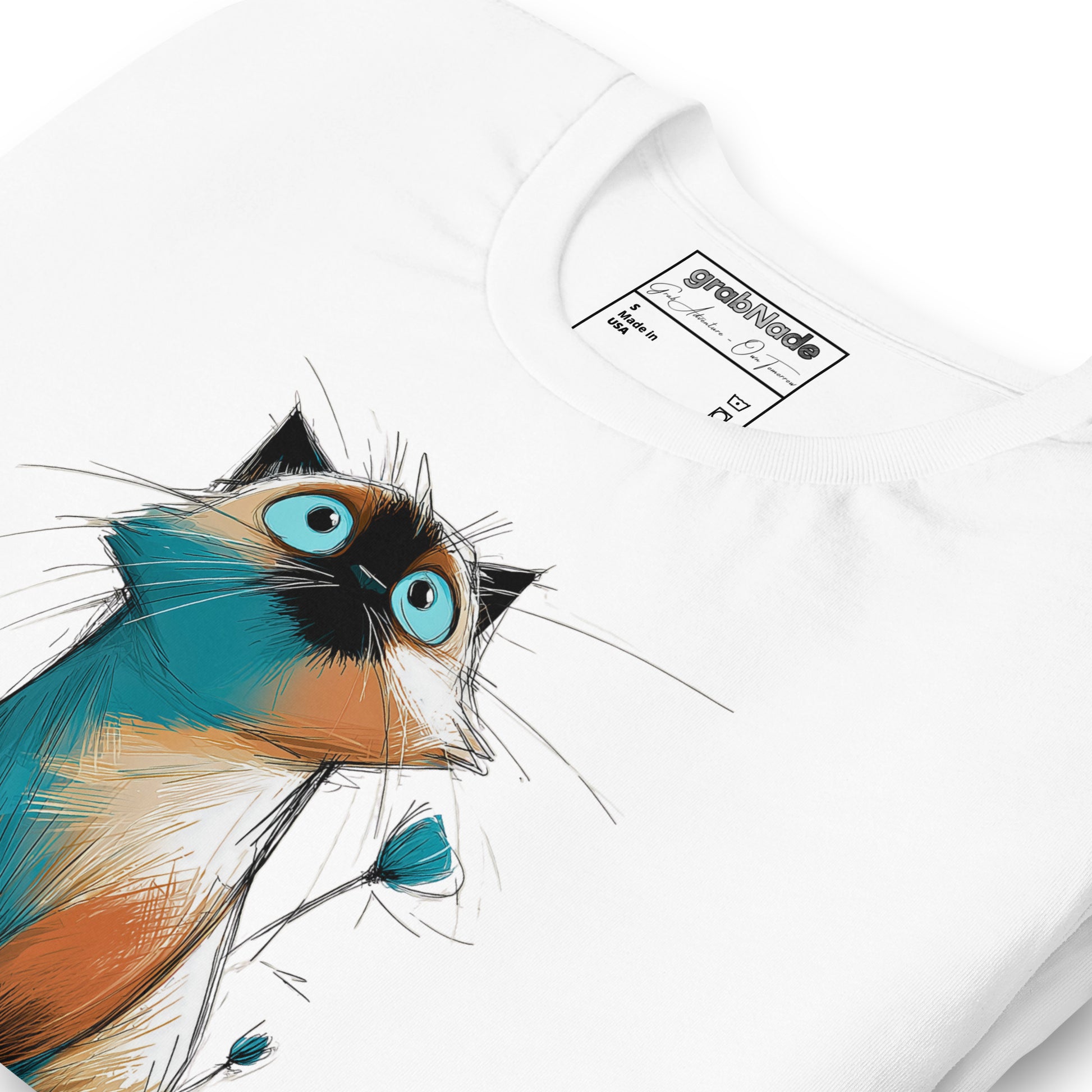 Product mockup. Close-up of a white T-shirt featuring a cartoon-style wide-eyed cat in shades of blue, tan, and black, looking upward.