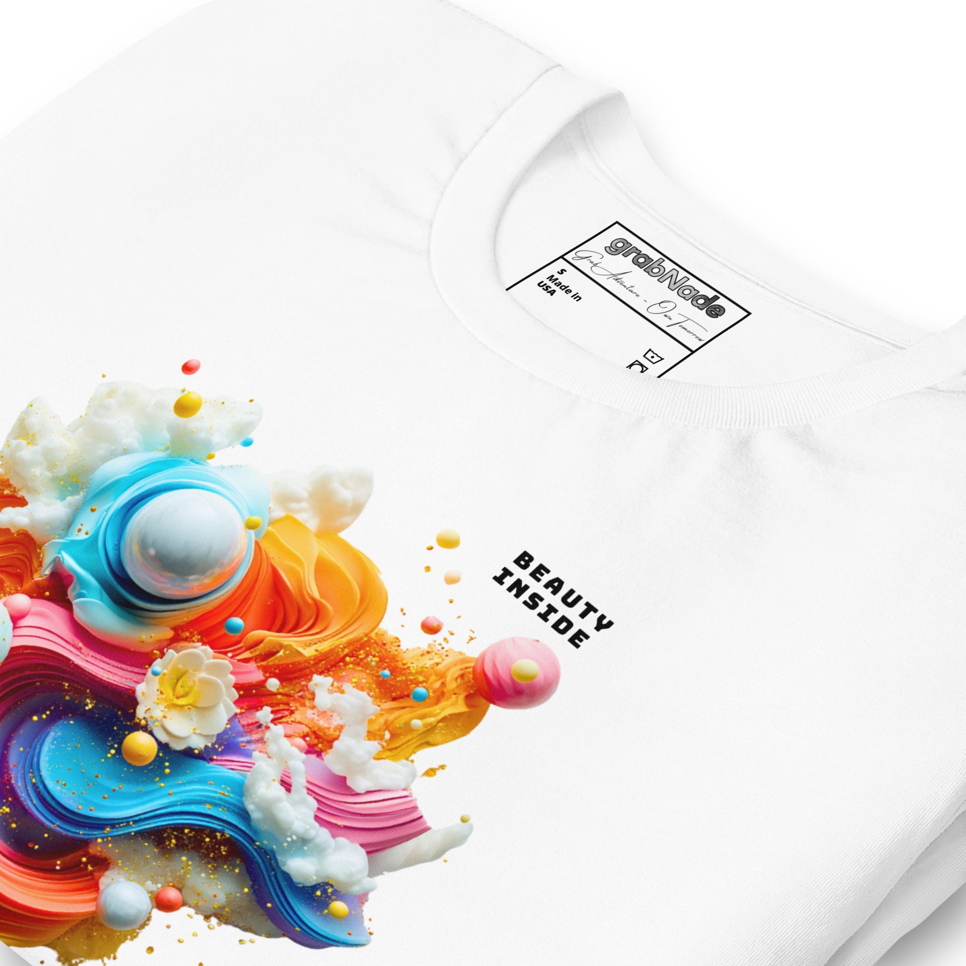Product mockup. Close-up view of a white T-shirt with a large, colorful 3D swirl of abstract shapes, spheres, and clouds and the text “BEAUTY INSIDE”.